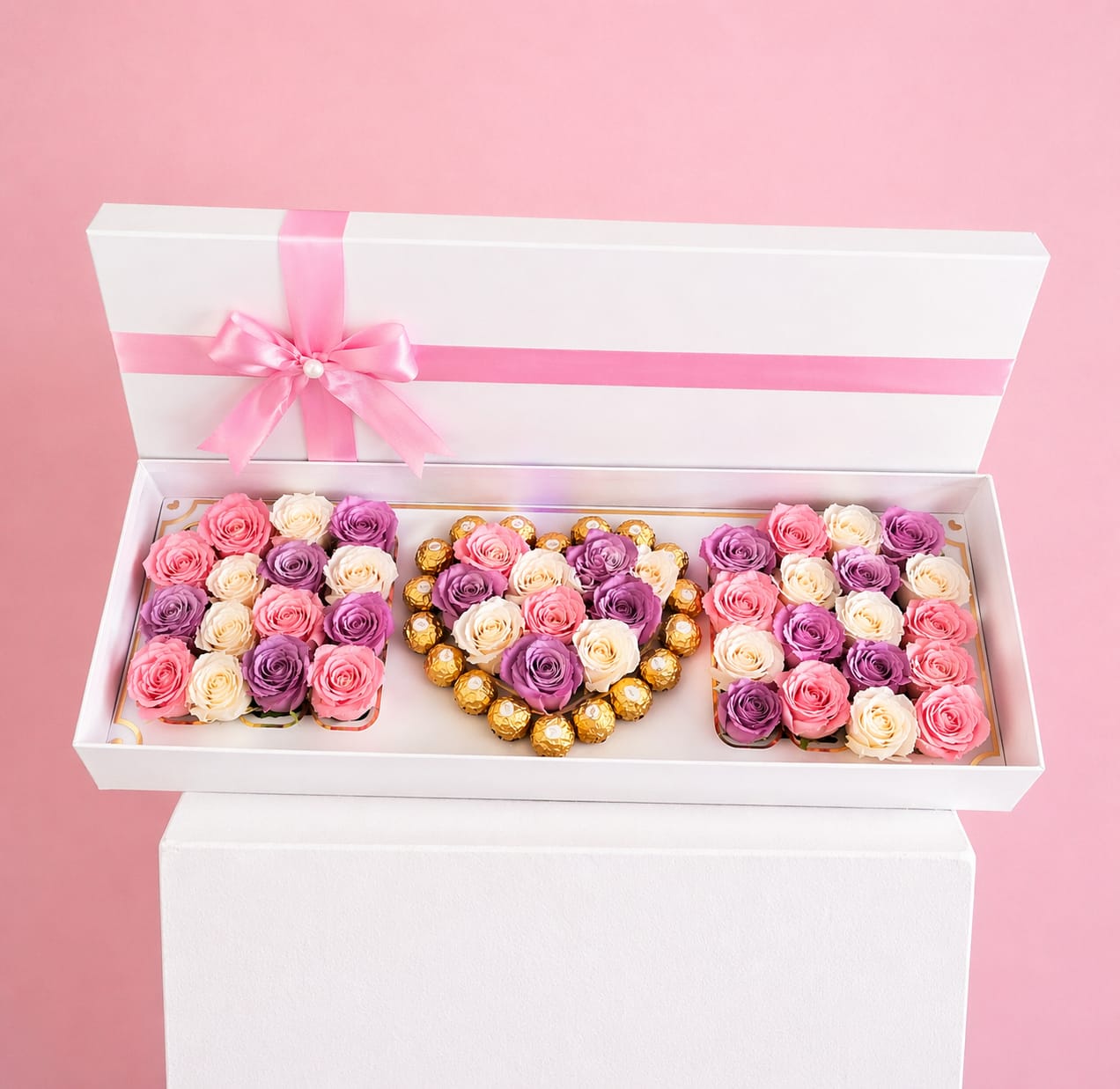 Colorful Mom Box - Celebrate Mom with a gift as beautiful and heartfelt as she is. This elegant Mother’s Day rose and chocolate box features fresh, premium roses in soft pink, lavender, and ivory tones, paired with delicious Ferrero Rocher chocolates for the perfect touch of sweetness. Designed in a sleek white box and finished with a delicate pink satin ribbon, this arrangement is the perfect balance of luxury and love.  Thoughtfully handcrafted, it’s an unforgettable way to say thank you and I love you—ideal for Mother’s Day celebrations or simply to make her feel extra special.  Flower colors and tones may vary slightly due to seasonal availability while maintaining the overall look and feel of the design.