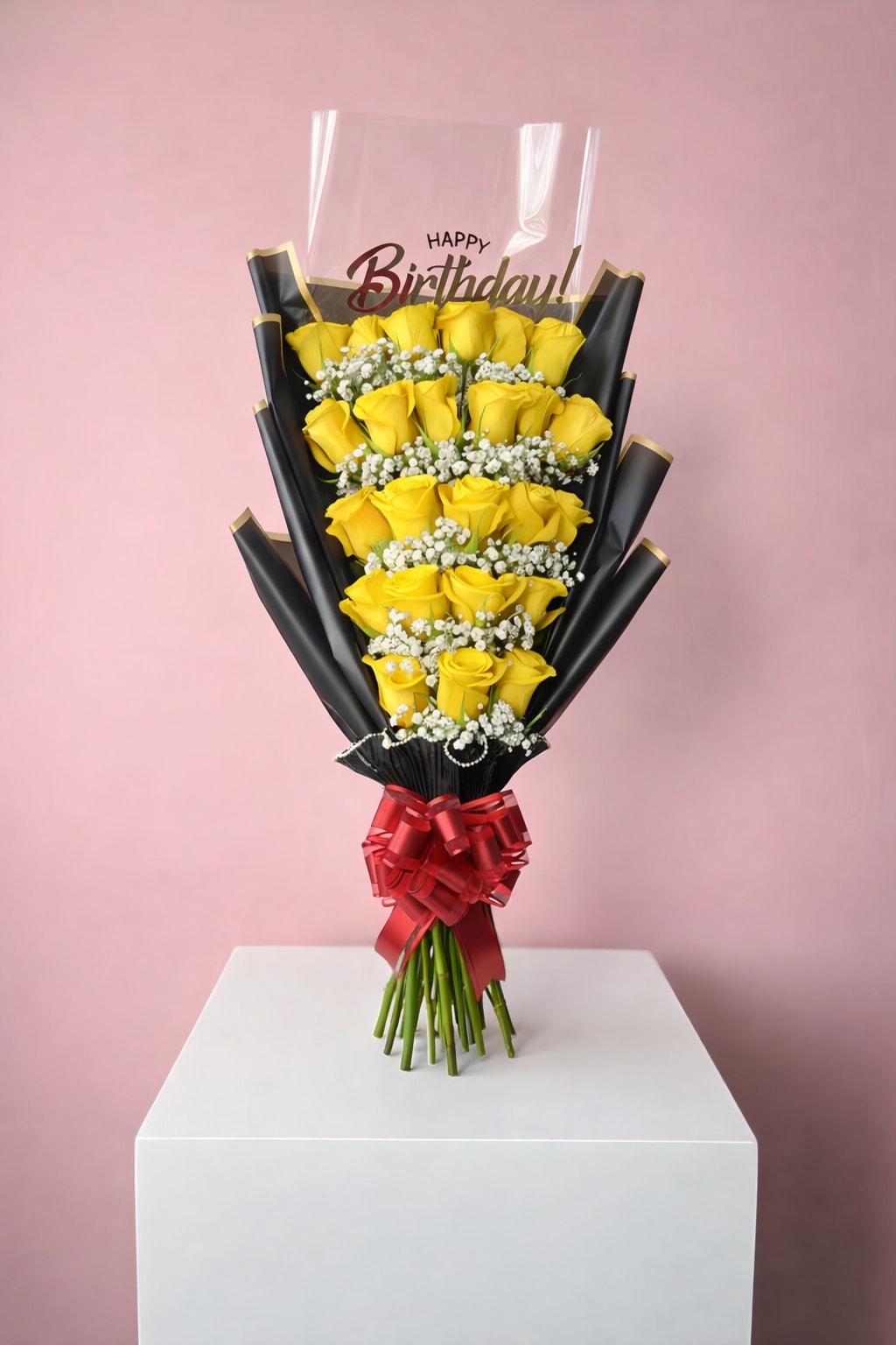 Bouquet of yellow roses with a birthday topper and red ribbon