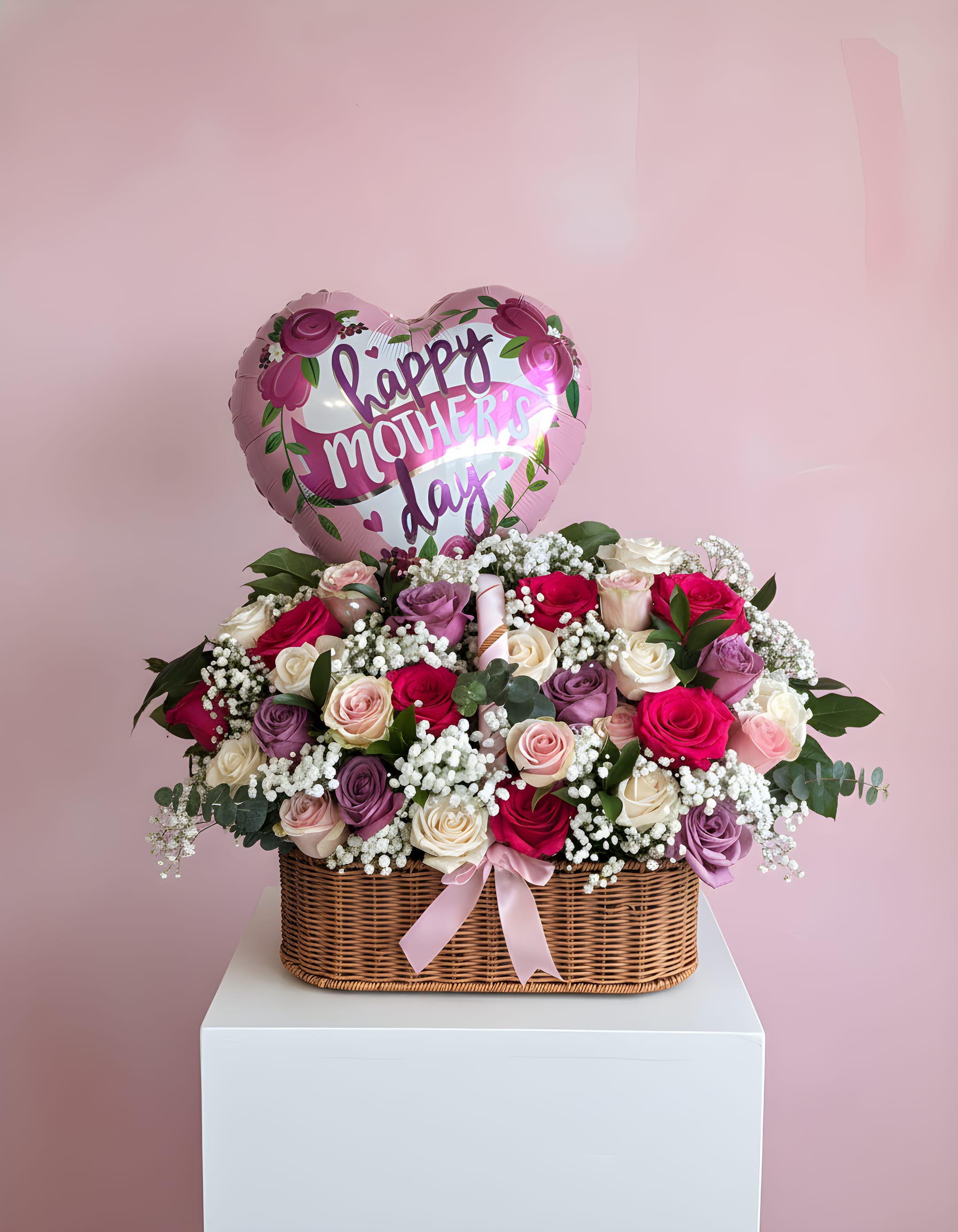 Mom Large Colorful Basket - This stunning Luxury Rose Basket is designed to impress at first sight. Overflowing with premium colorful roses, soft pink roses, spray roses, lush greenery, and touches of eucalyptus, it creates a romantic and elegant statement piece perfect for anniversaries, birthdays, proposals, Valentine’s Day, or any special celebration. Arranged in a beautiful hand-woven wicker basket and finished with a soft satin bow, this design brings a luxurious floral touch to any space. Colors and rose varieties may vary depending on seasonal availability.