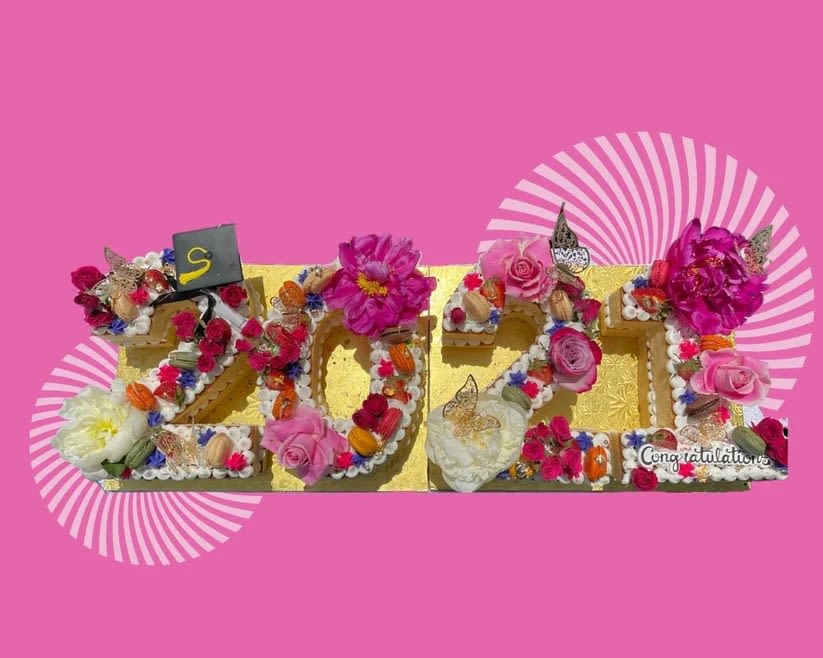 Decorative floral arrangement spelling 2024 with pink and white flowers