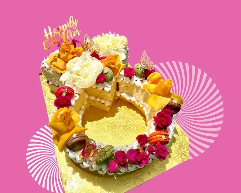 Decorated cake with flowers and a "Happily Ever After" topper