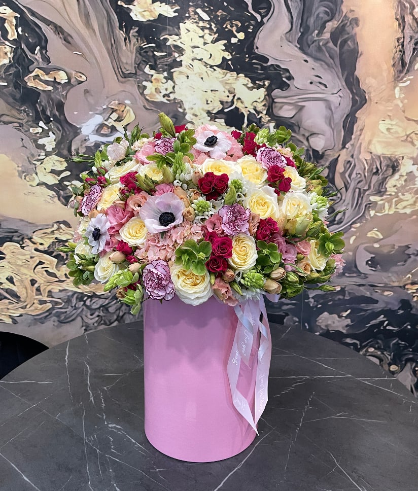 Large mixed bouquet in a pink cylindrical box with ribbon