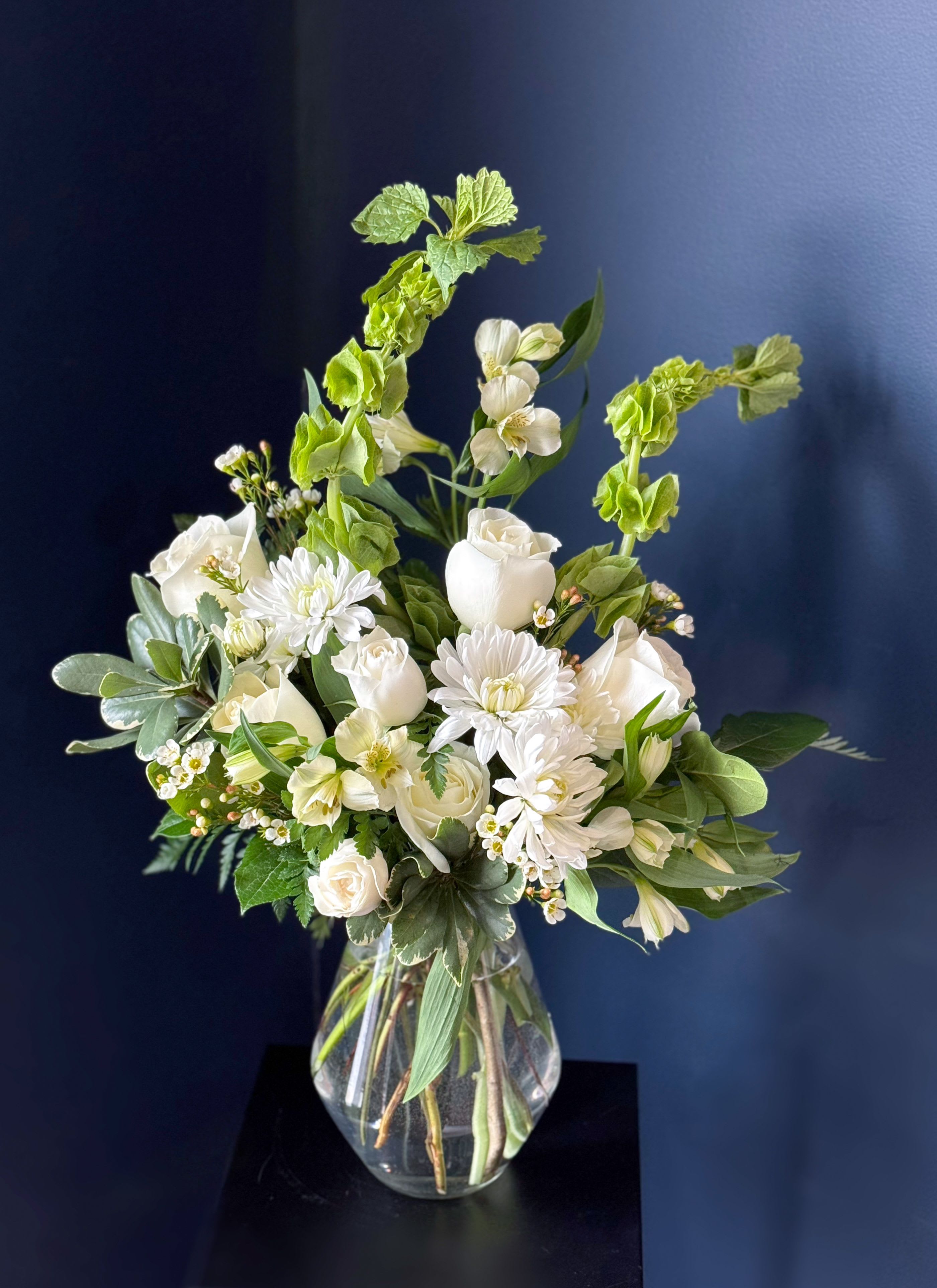 White floral arrangement in a clear glass vase