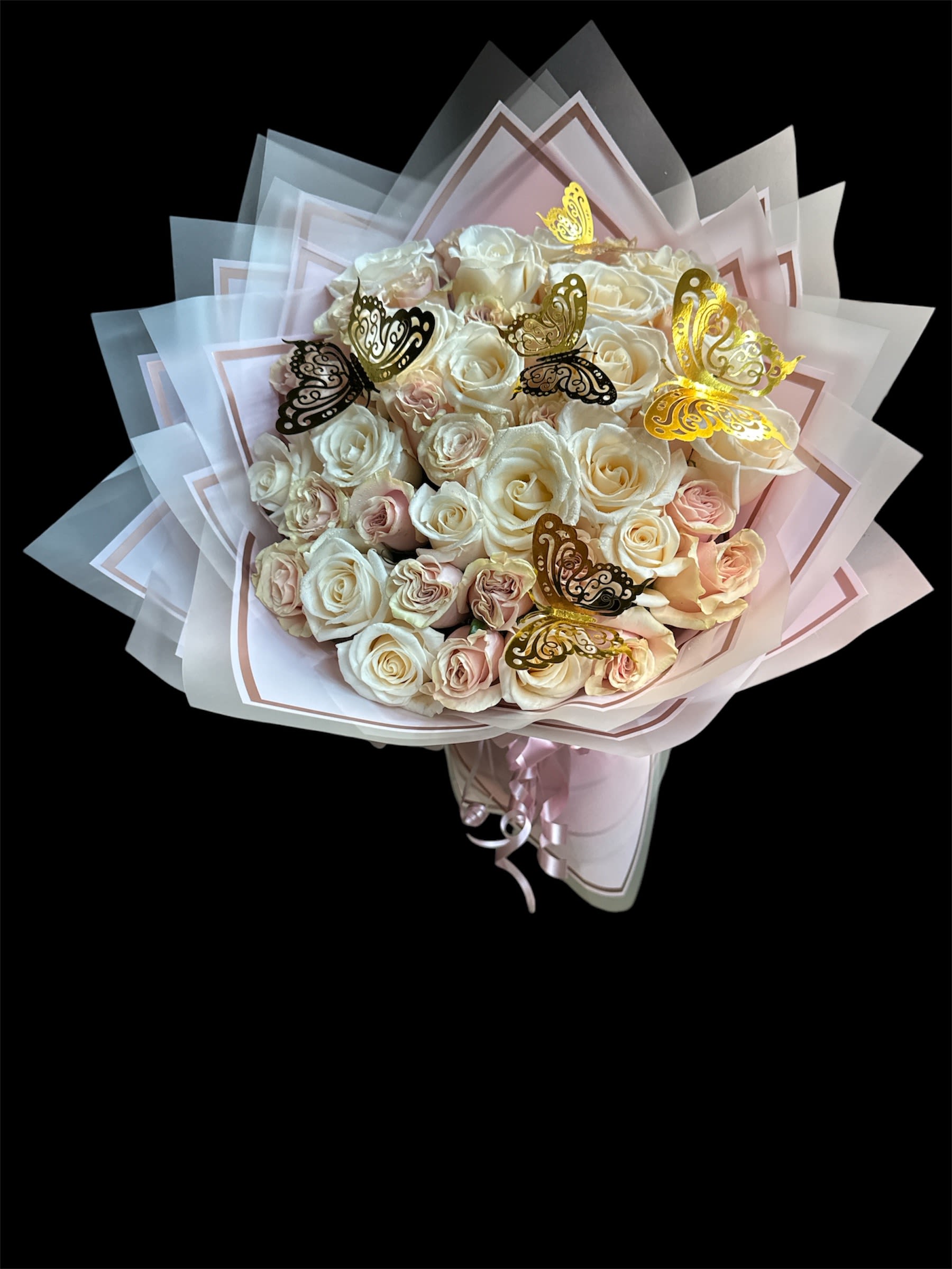 Bouquet of cream and blush roses with butterfly decorations