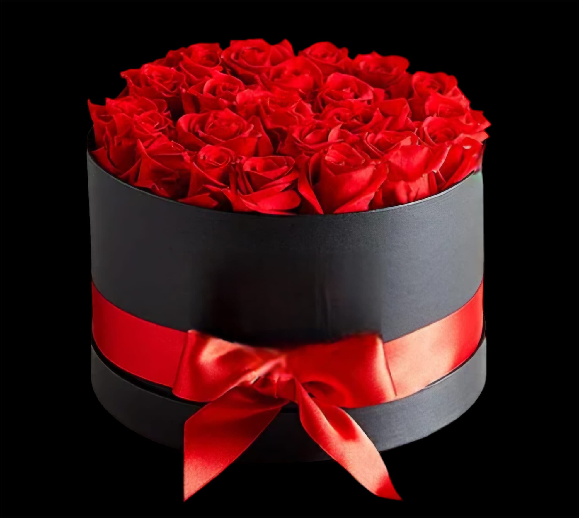 Red roses arranged in a black round box with a red ribbon