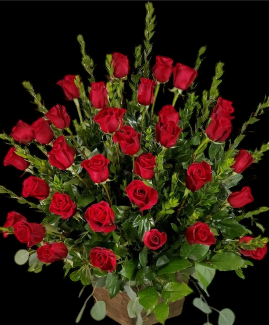 Bouquet of red roses with greenery in a basket