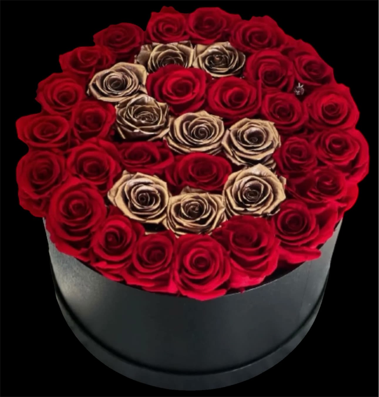 Round box of red and beige roses on a black background