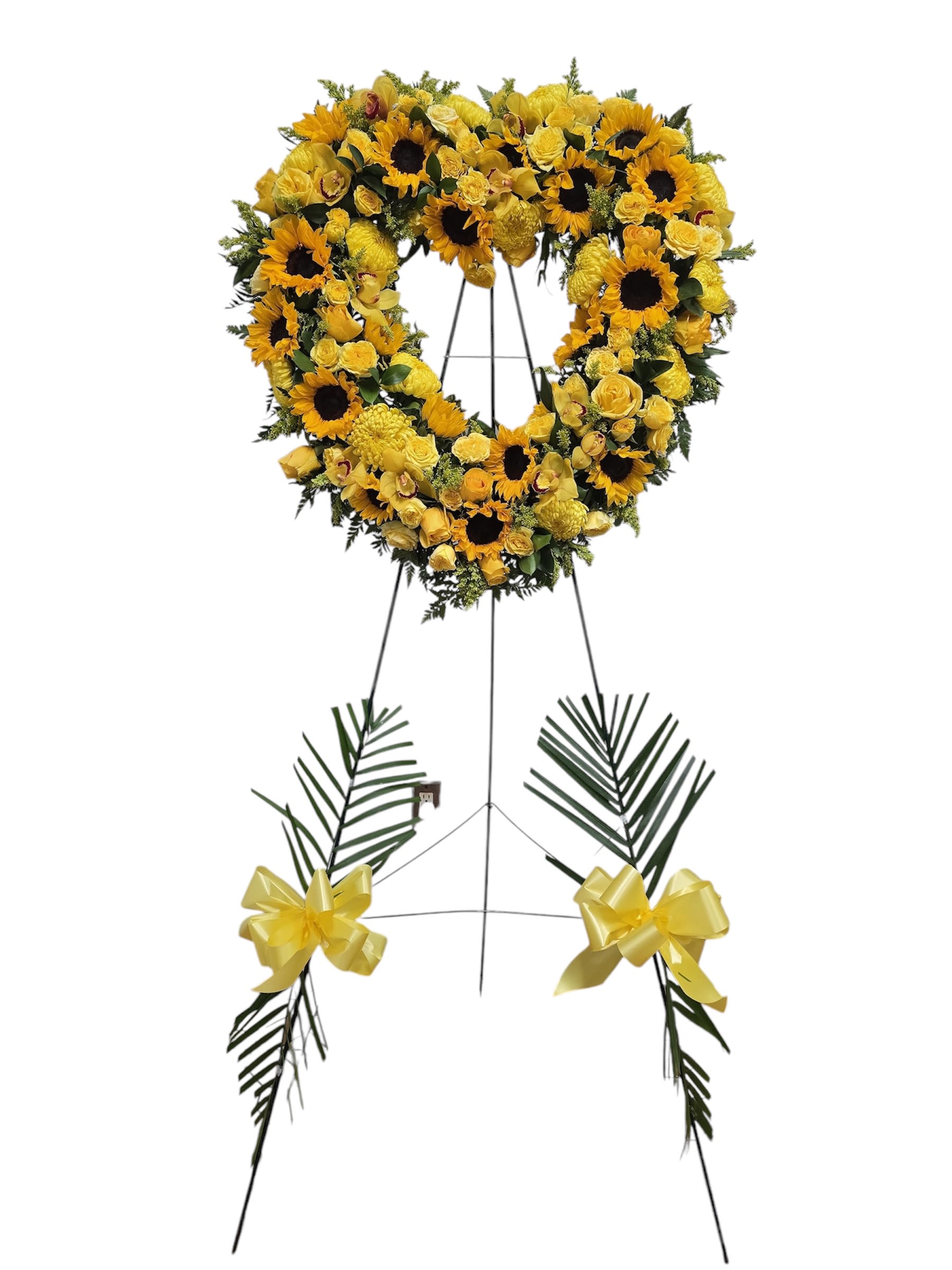 Yellow floral heart wreath on a standing easel with ribbon bows