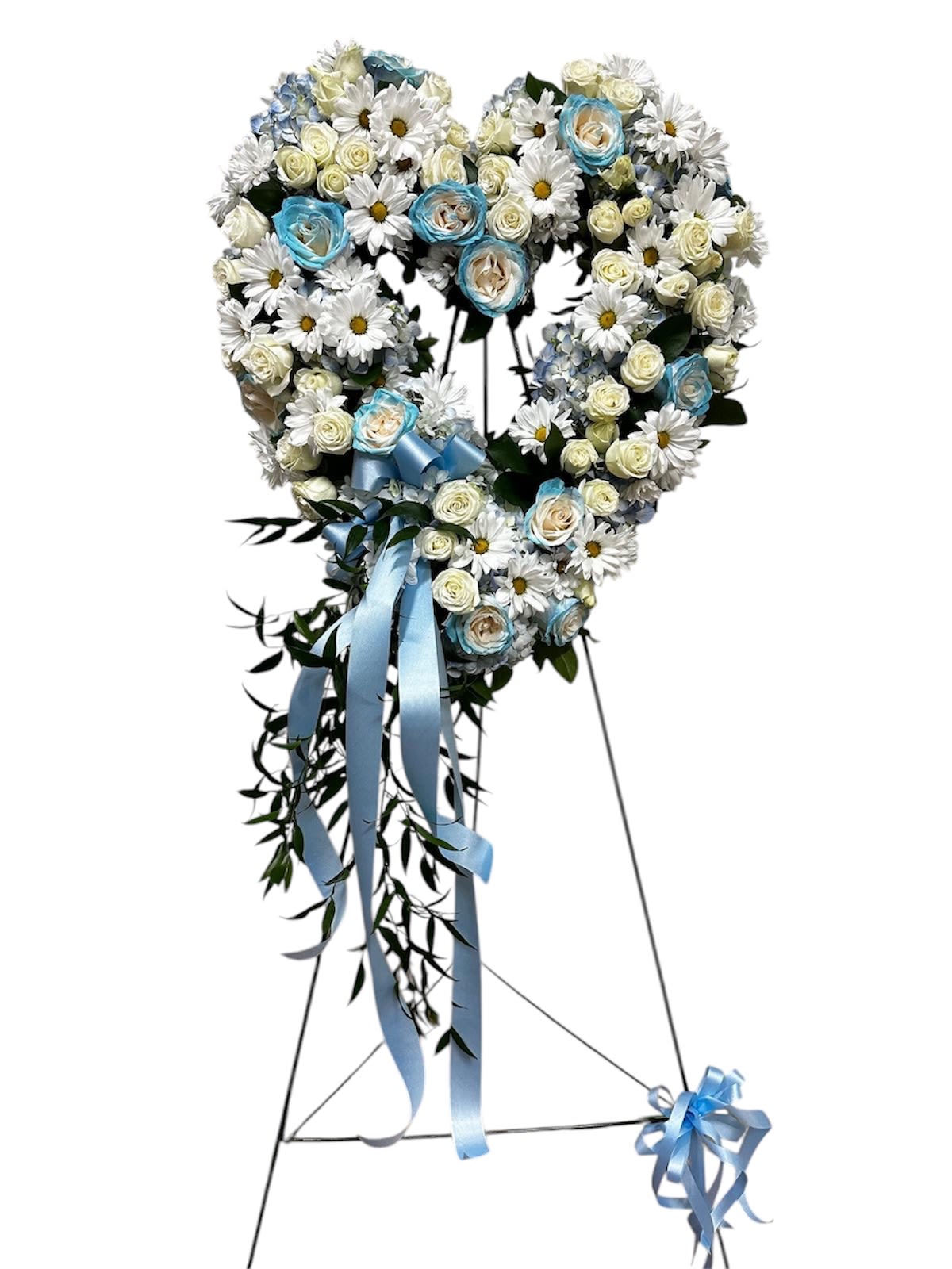 Heart-shaped floral wreath with white daisies, cream roses, and blue ribbon
