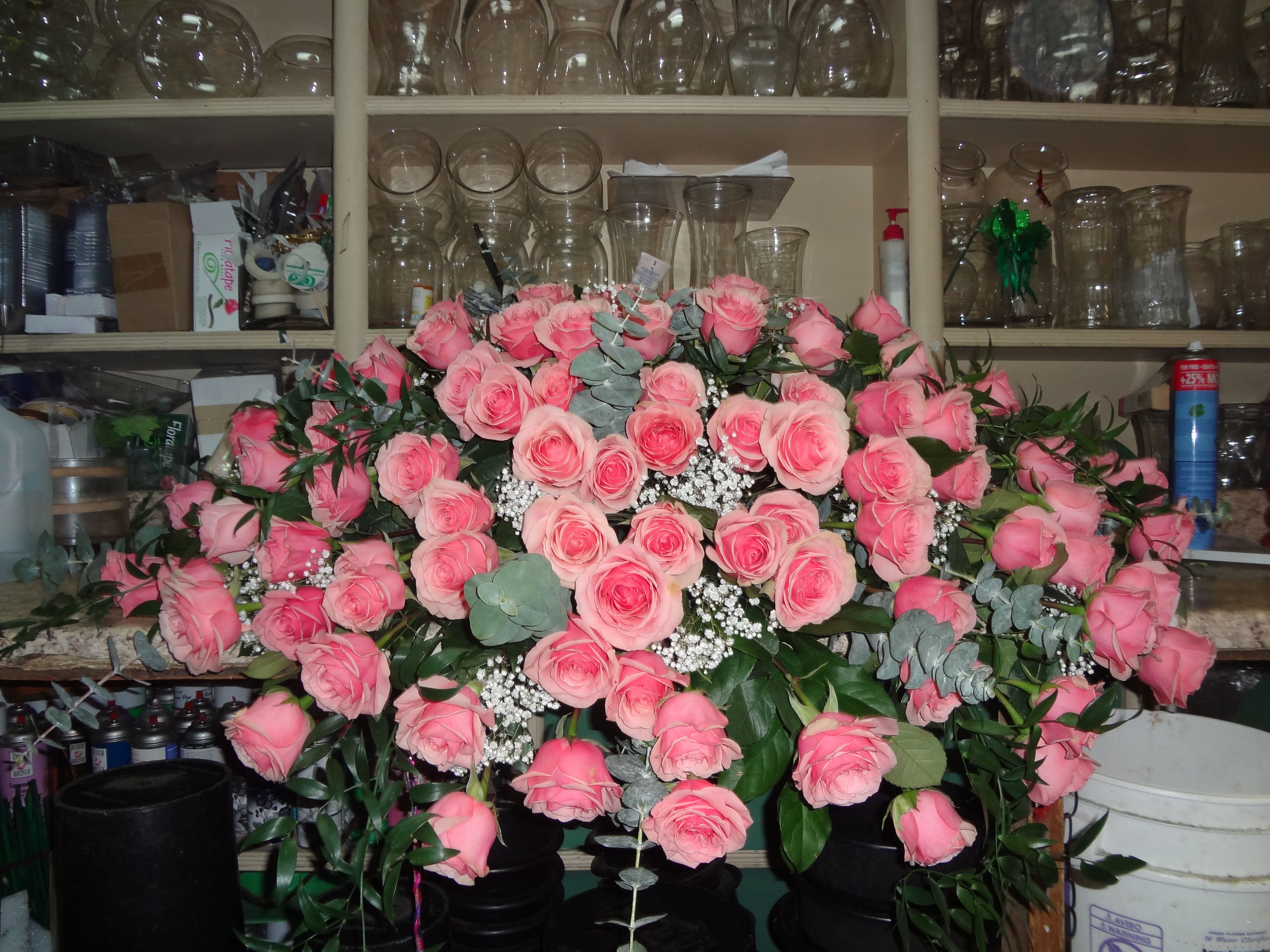 Large bouquet of pink roses with baby's breath in a vase
