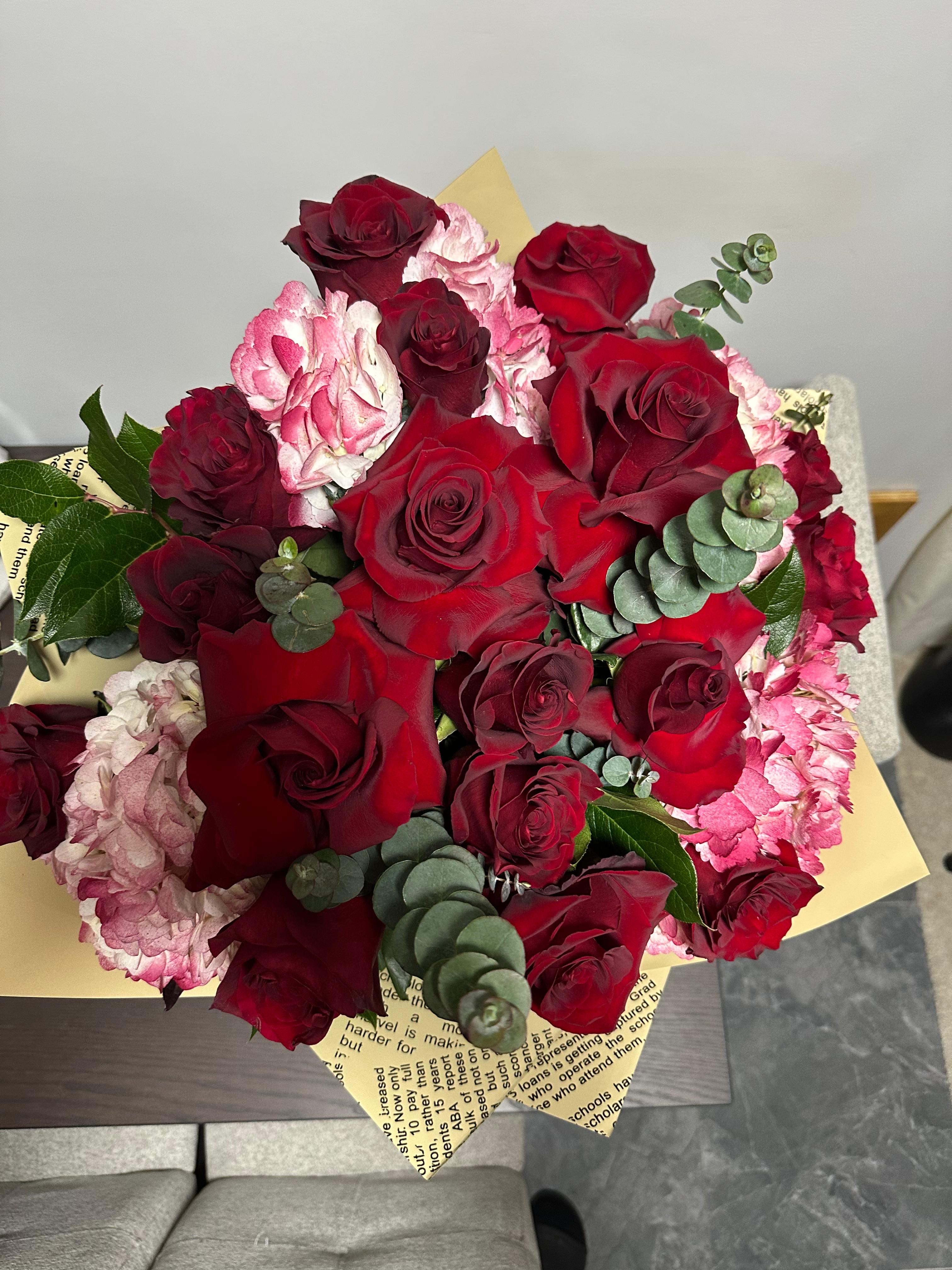 Bouquet of red roses and pink hydrangeas with eucalyptus