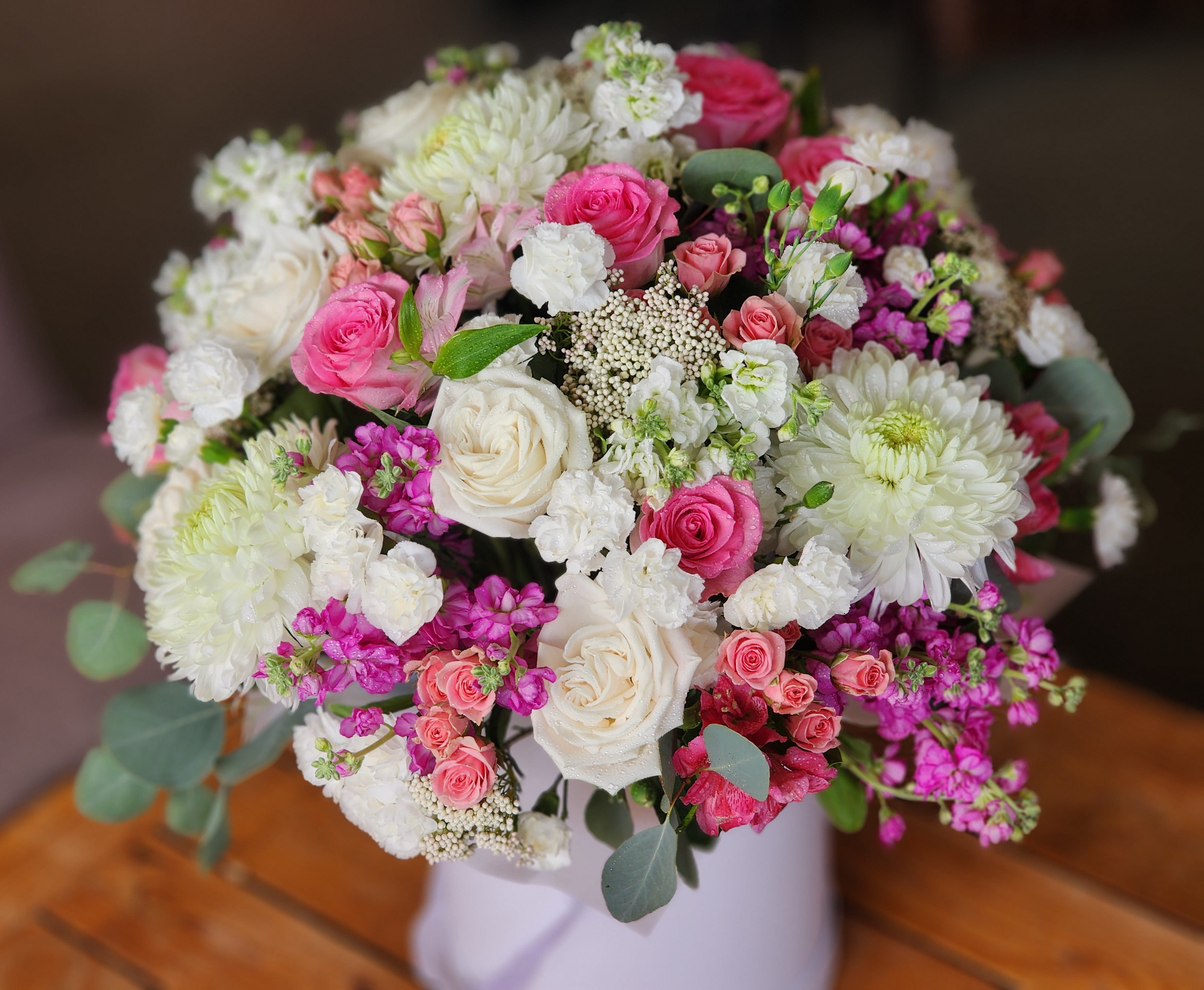 Bouquet of pink and white roses with white chrysanthemums in a vase
