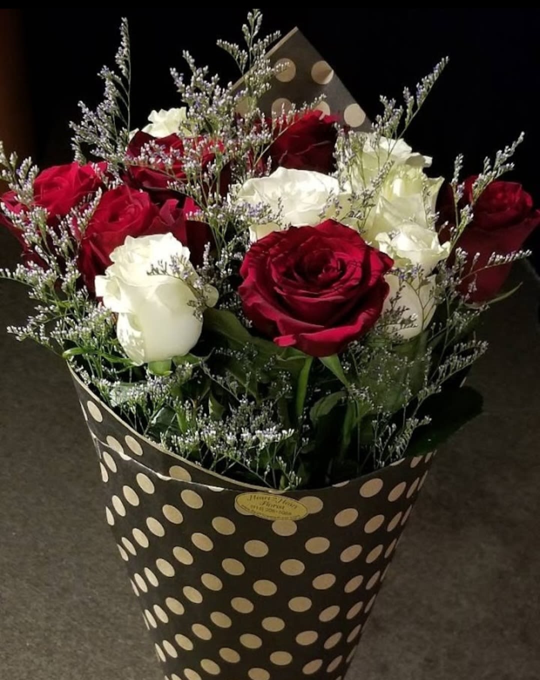 Bouquet of red and white roses in a polka-dot wrap