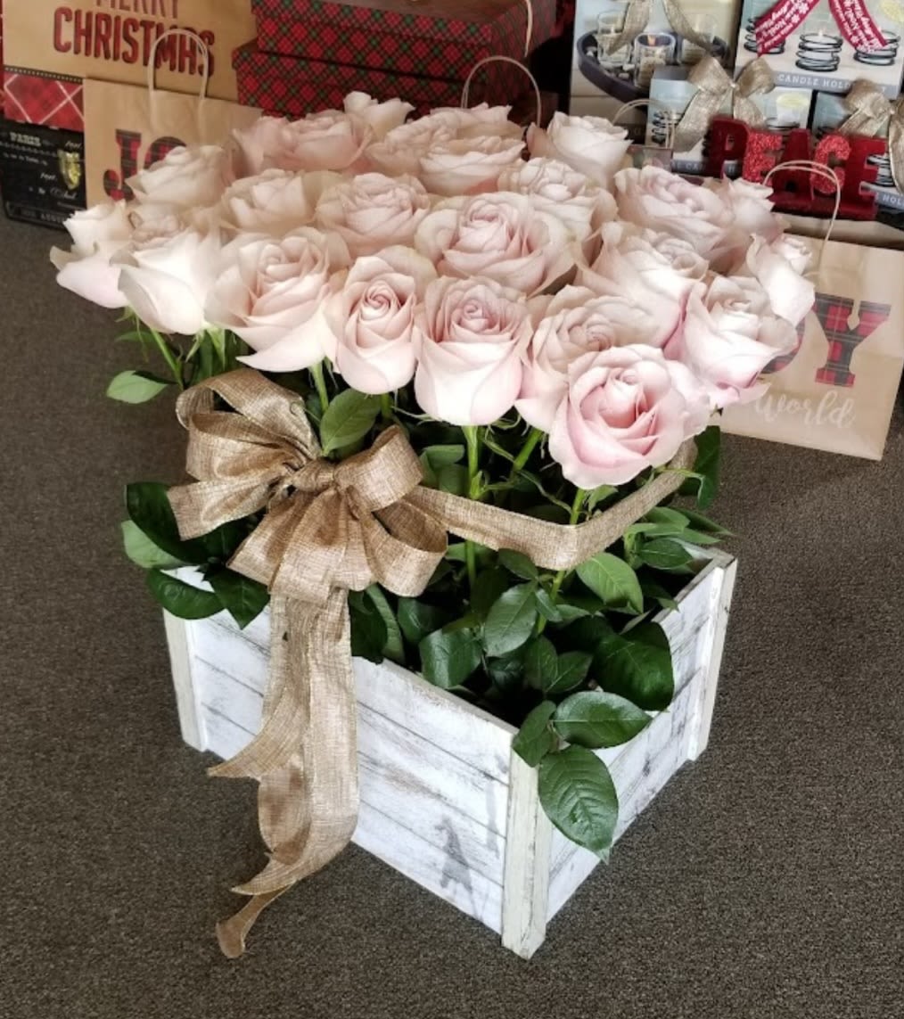 Box of pale pink roses with a burlap ribbon