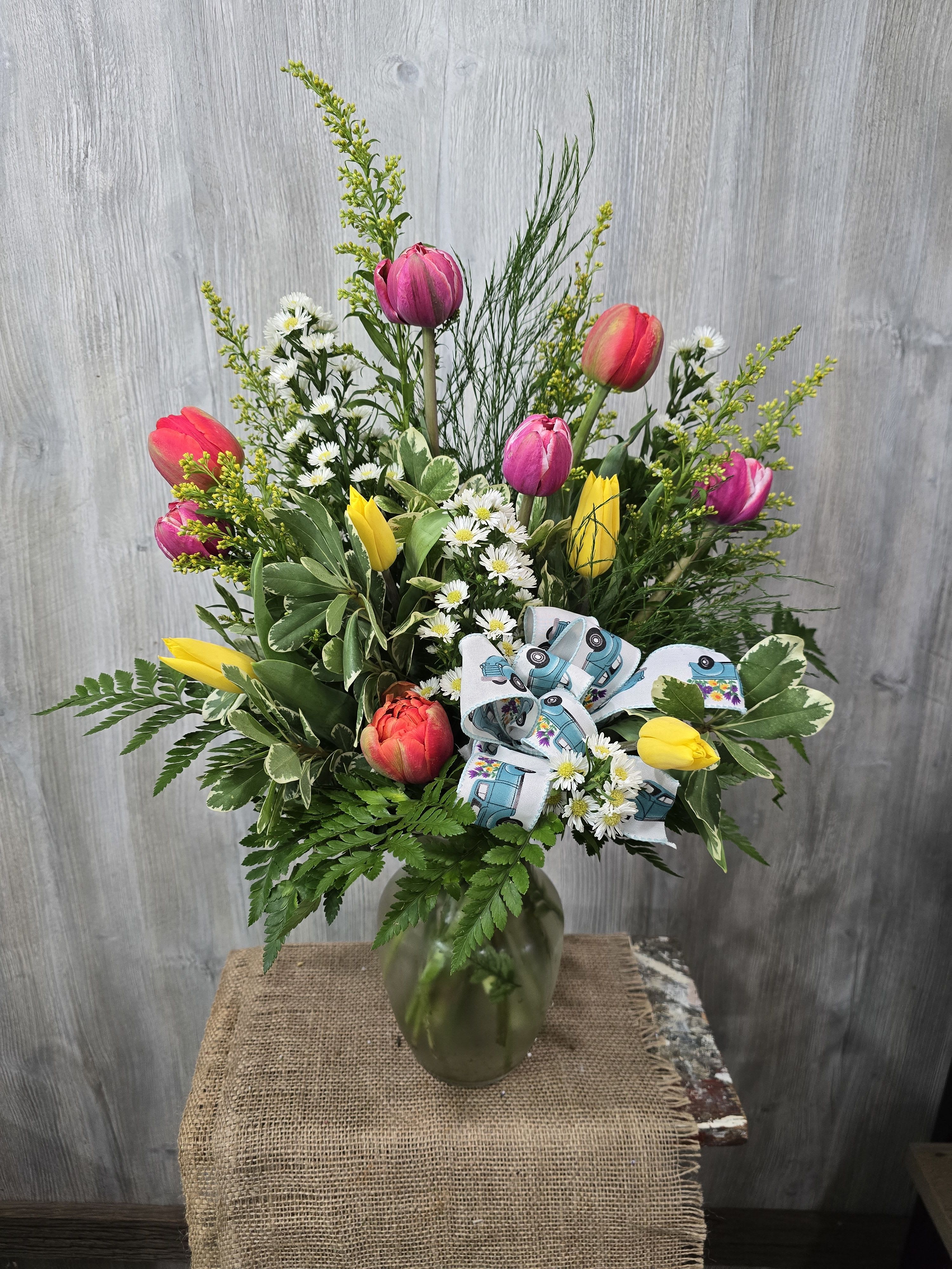 Tulip Nation  - A beautiful mixture of greens and filler beautifully arranged with Tulips!   Deluxe and premium pricing includes more flowers for a fuller and bigger vase arrangement. 