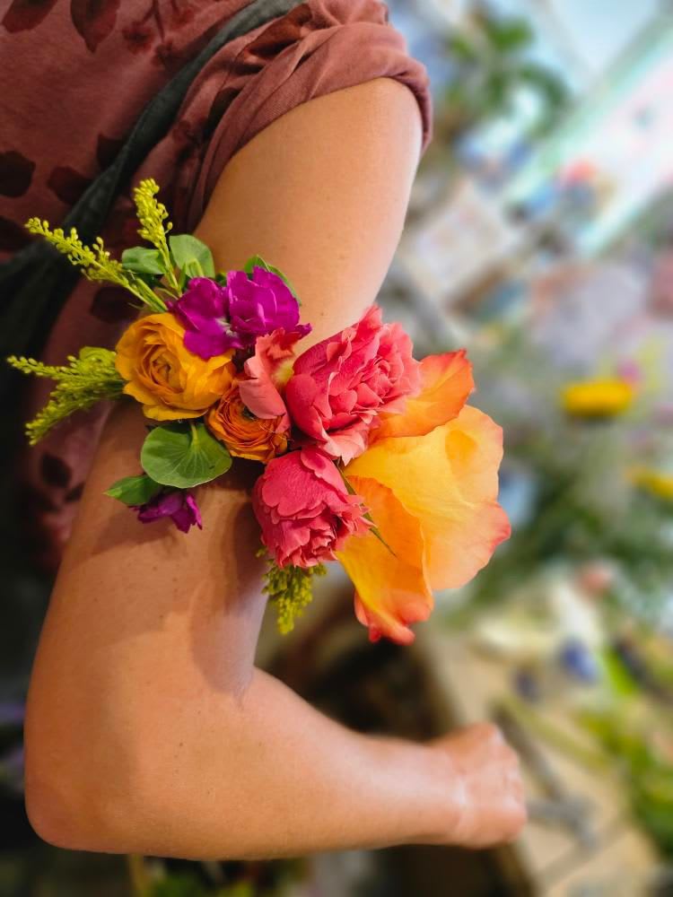 Colorful flower corsage on a person's wrist
