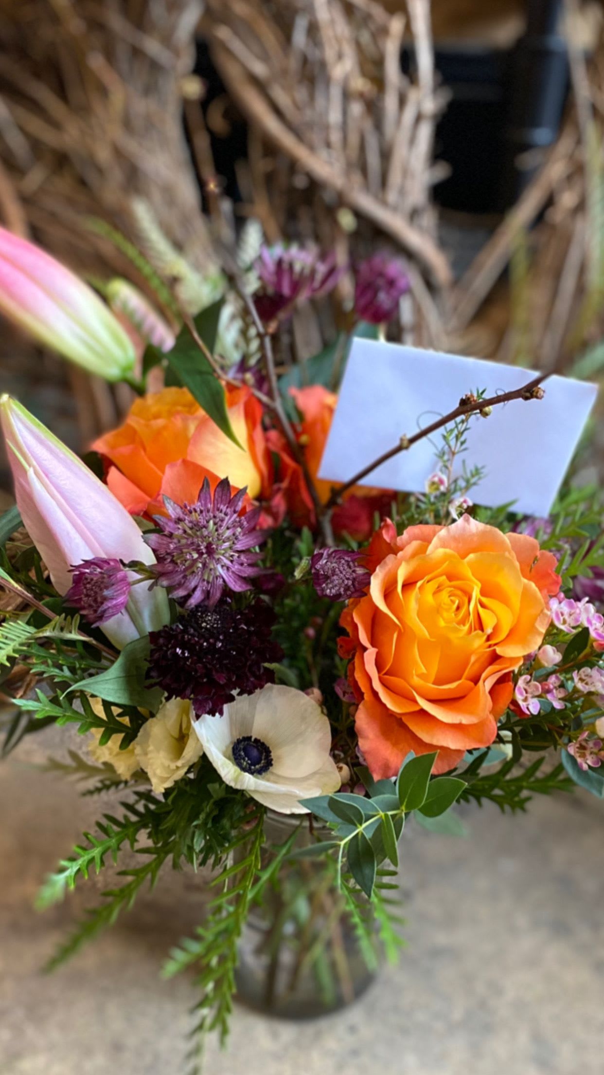 Bouquet of orange roses and white poppies in a vase