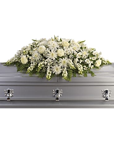 Enduring Light Casket Spray - This exquisite casket spray of artistically arranged white flowers is like a blanket of love and caring. It is a very personal farewell to someone who will be deeply missed. The elegant arrangement includes white alstroemeria, white snapdragons, white chrysanthemums, white spider chrysanthemums and million star gypsophila, accented with assorted greenery. Orientation: N/A  SUBSTITUTION POLICY – Always deliver the freshest flowers! Please note the bouquet pictured reflects our original design.  If the exact flowers or container in this arrangement are not available, our local florists will create a beautiful bouquet with the freshest available flowers.