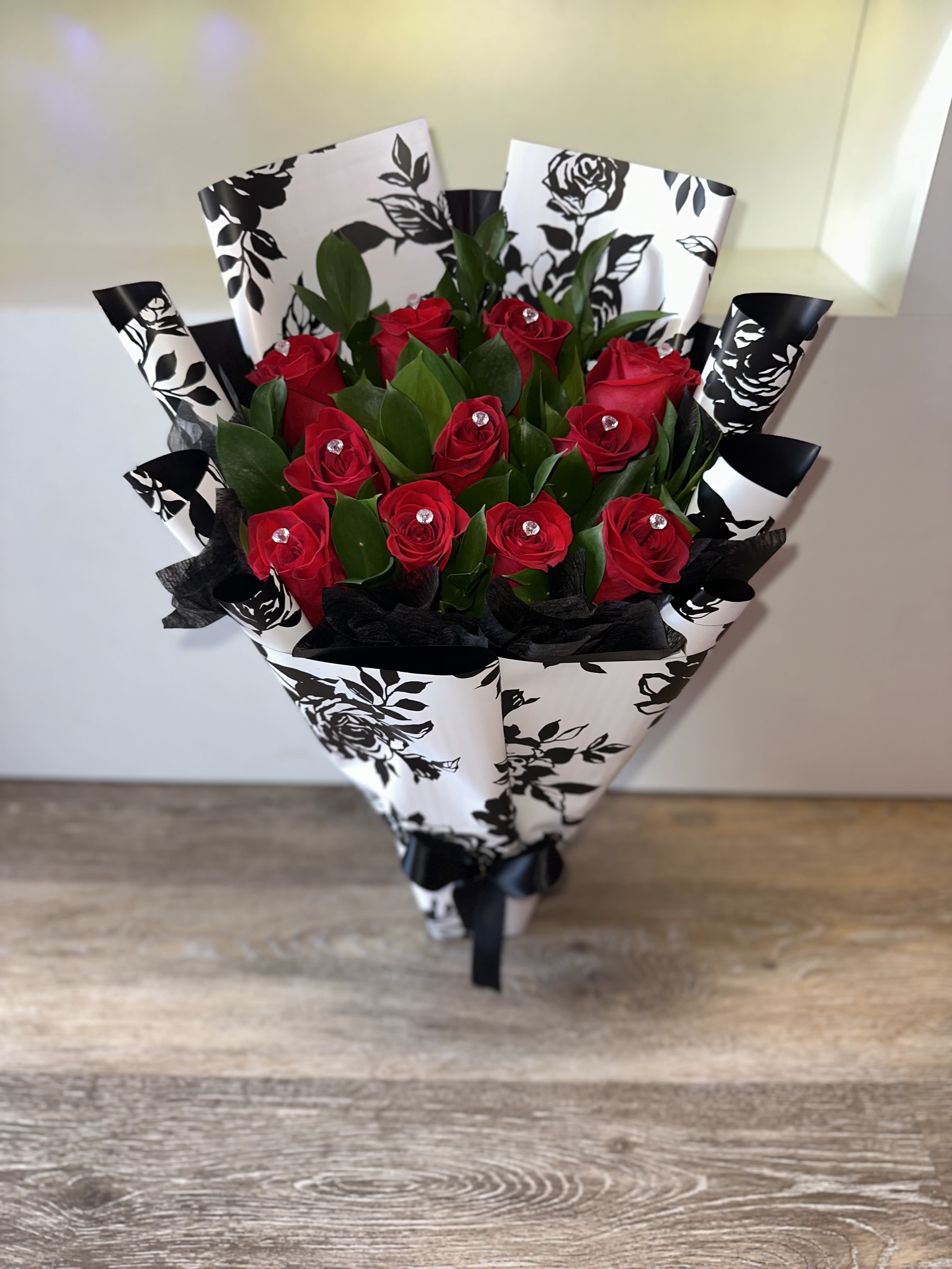 Bouquet of red roses wrapped in black-and-white paper