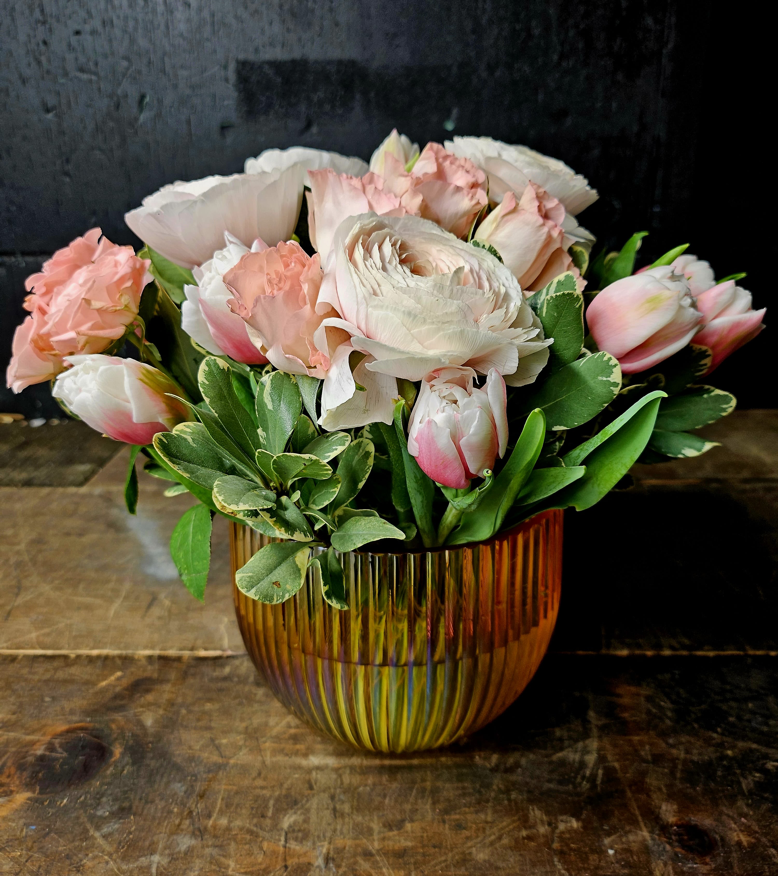 Pink and white bouquet in an amber glass vase