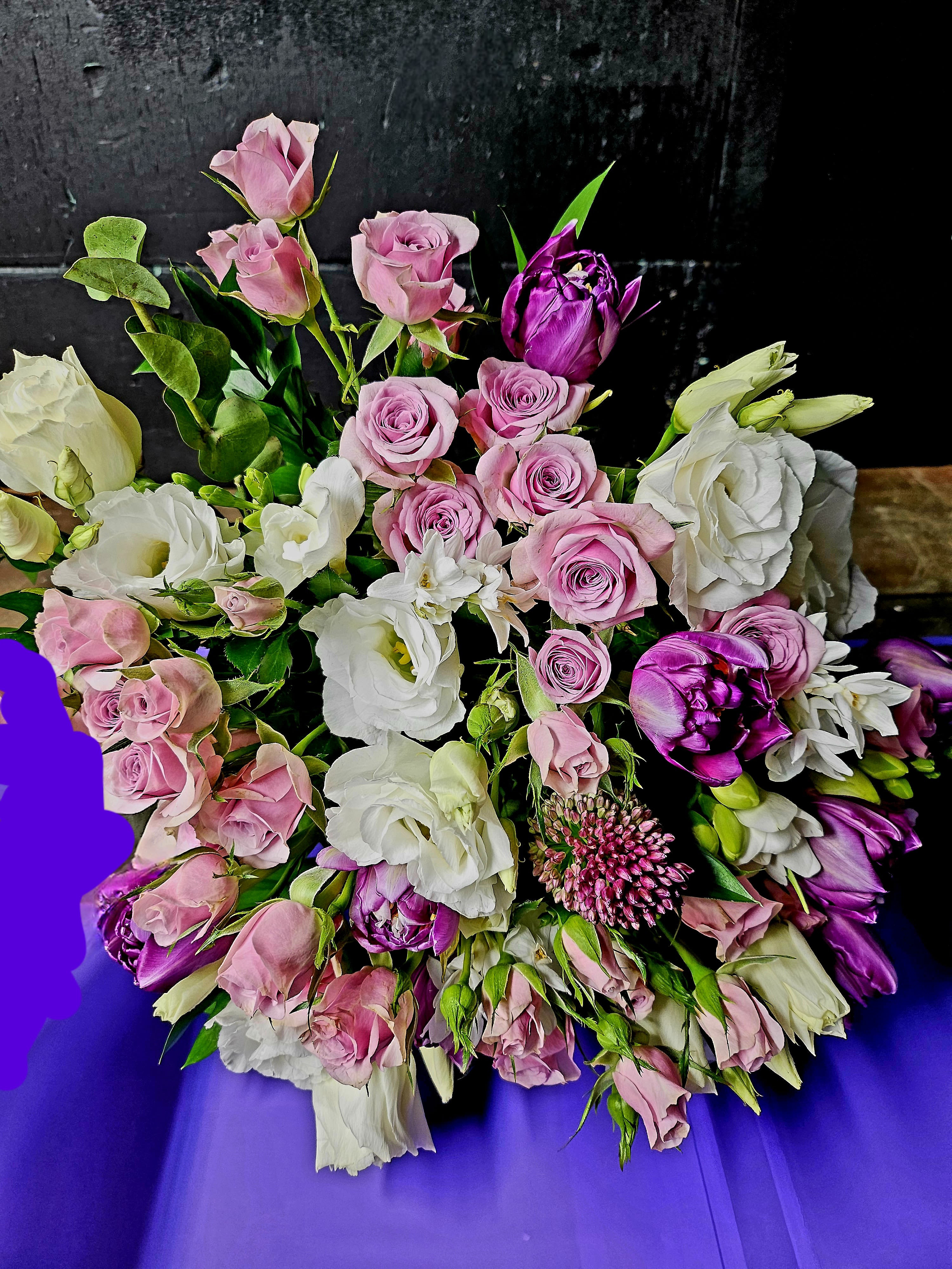 Bouquet of pink and white roses with purple blooms