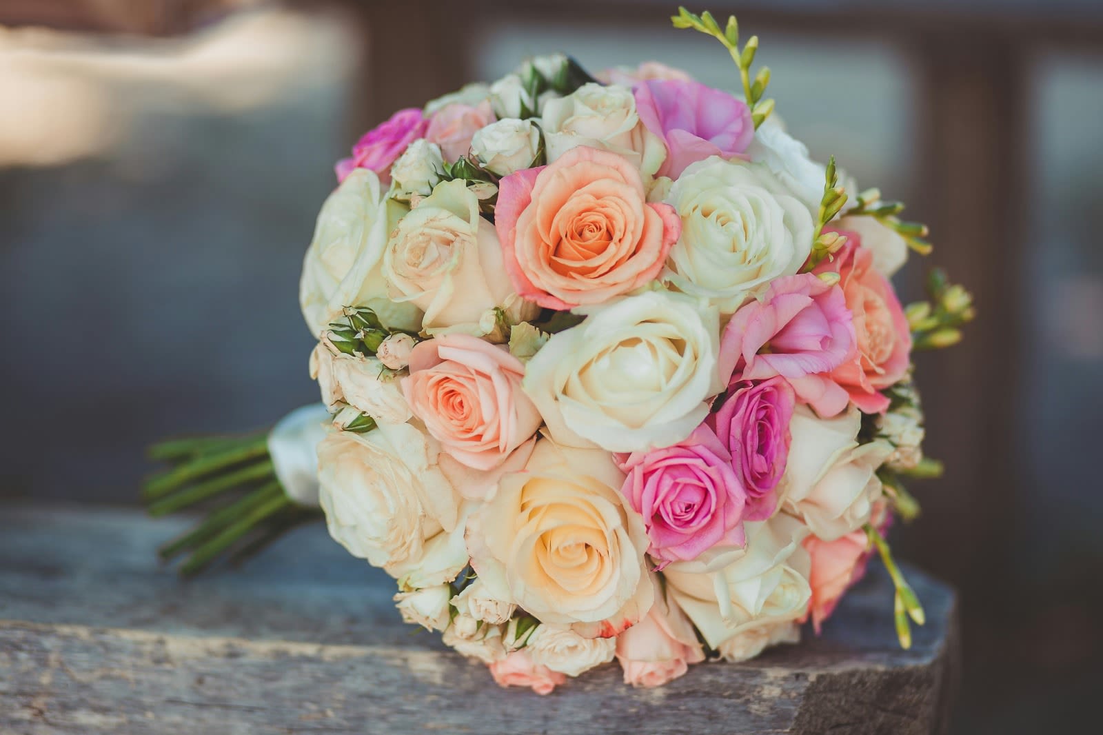 Bouquet of pastel roses in cream, pink, and peach