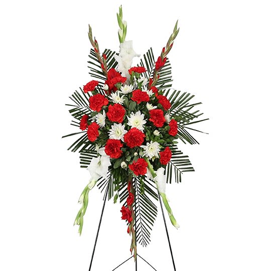Standing funeral spray with red and white flowers on an easel