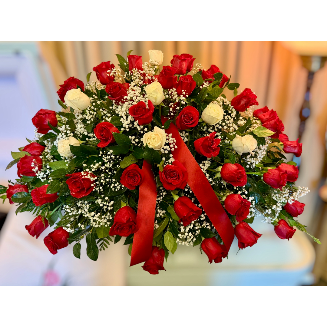 Red and white rose bouquet with baby's breath and a red ribbon