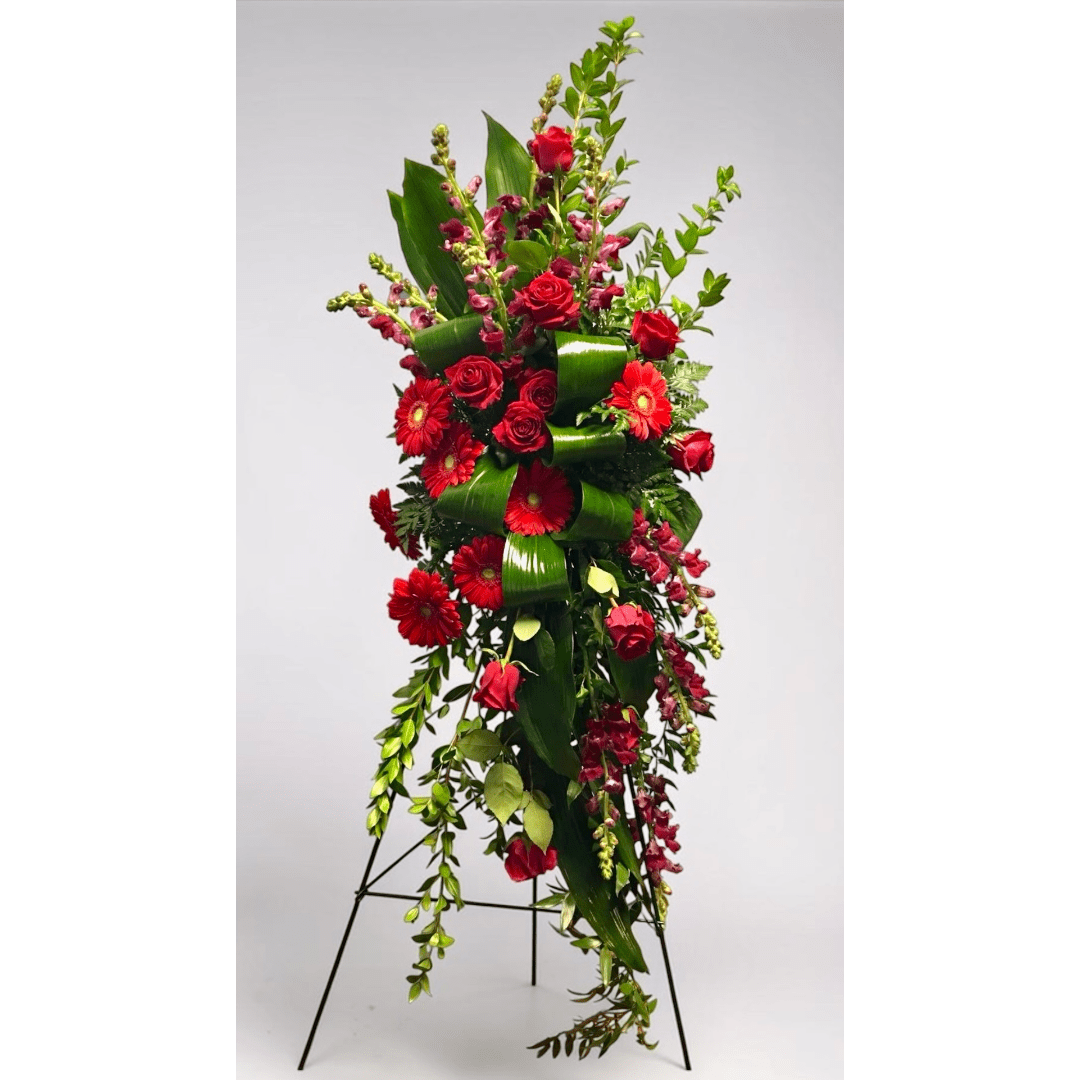 Tall red floral standing arrangement with roses and gerbera daisies