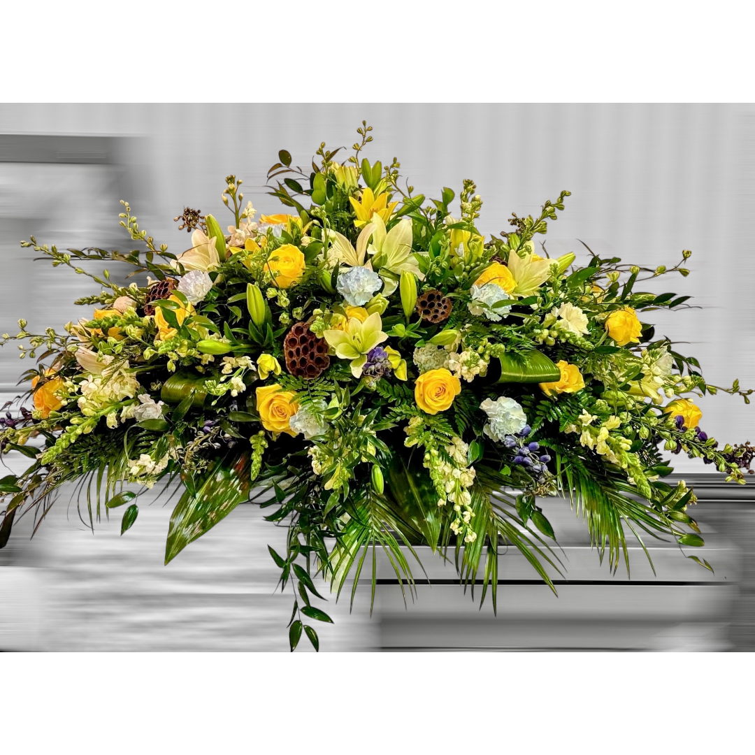 Large yellow and white floral arrangement with lilies and roses