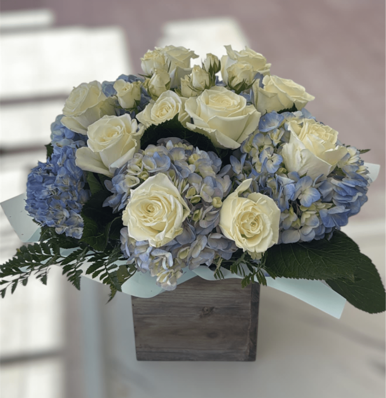 Sail Away by BloomNation™ - Send something to let them know you care. Featuring blue hydrangea, and white roses this arrangement is a nice way to show you are thinking of somebody in their time of need.