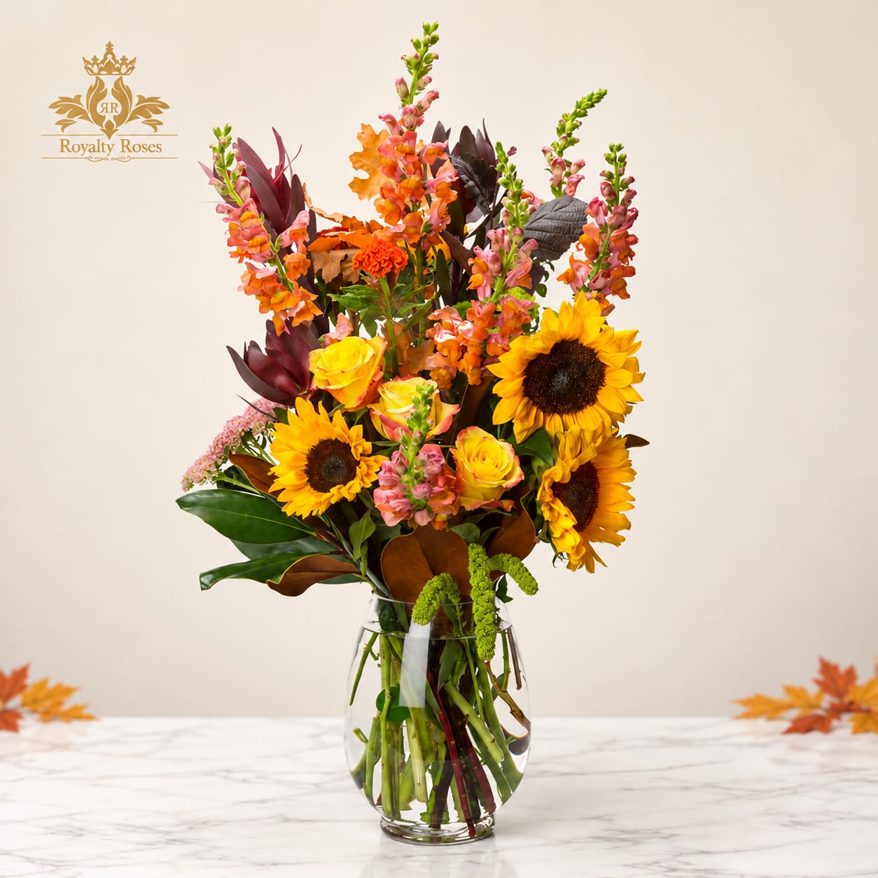 Tall mixed bouquet with sunflowers and roses in a clear glass vase