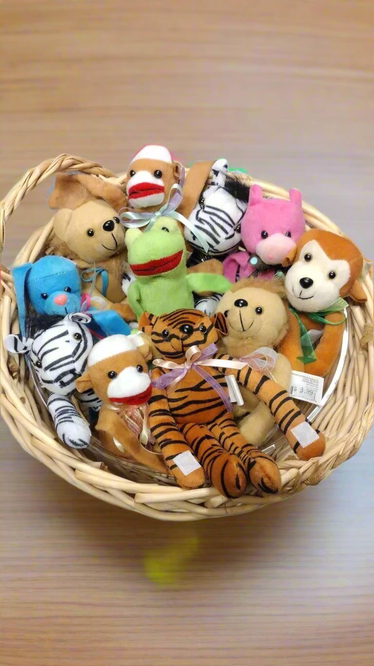 Basket of small animal plush toys in assorted colors
