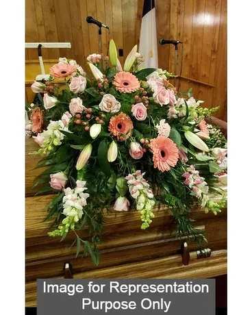Large pink and white floral casket spray with lilies and roses