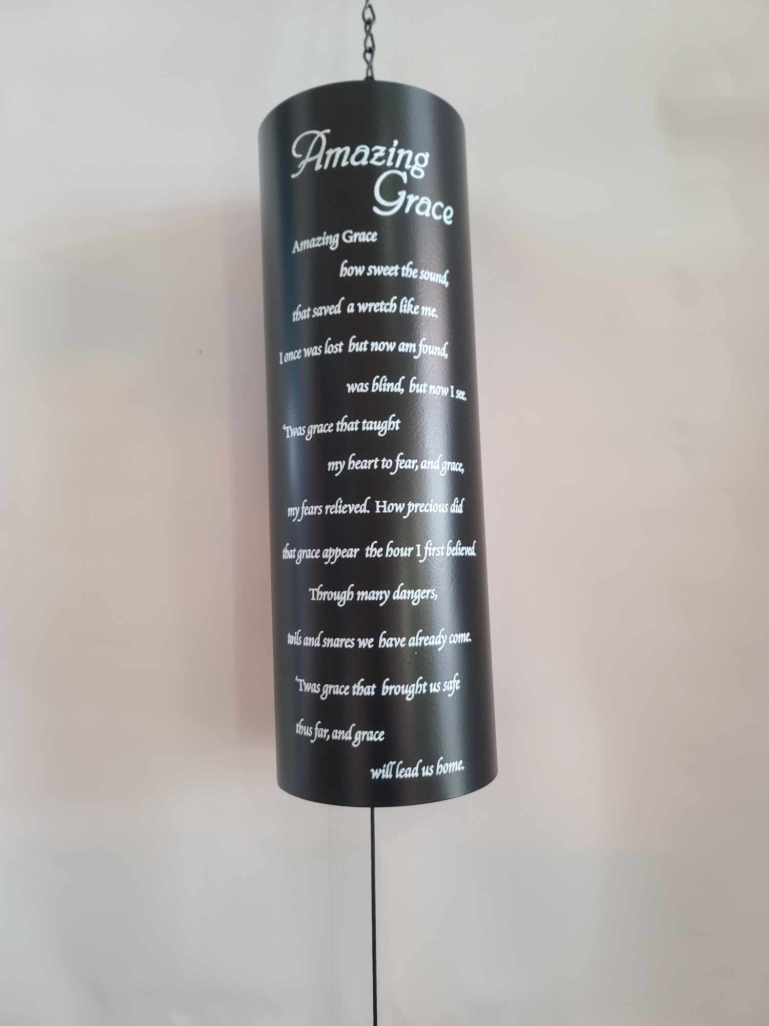 Black hanging memorial plaque with white "Amazing Grace" text