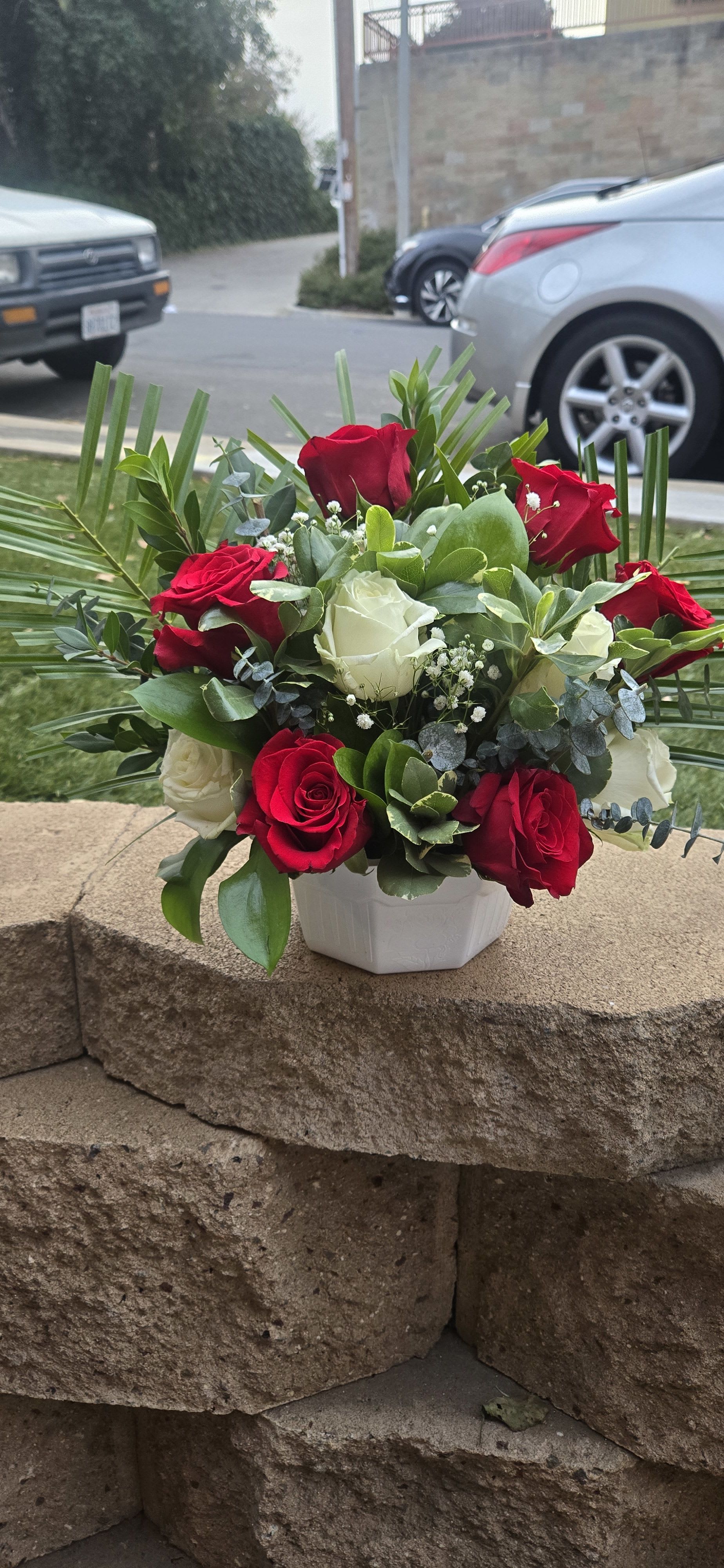 Bouquet of red and white roses in a white vase
