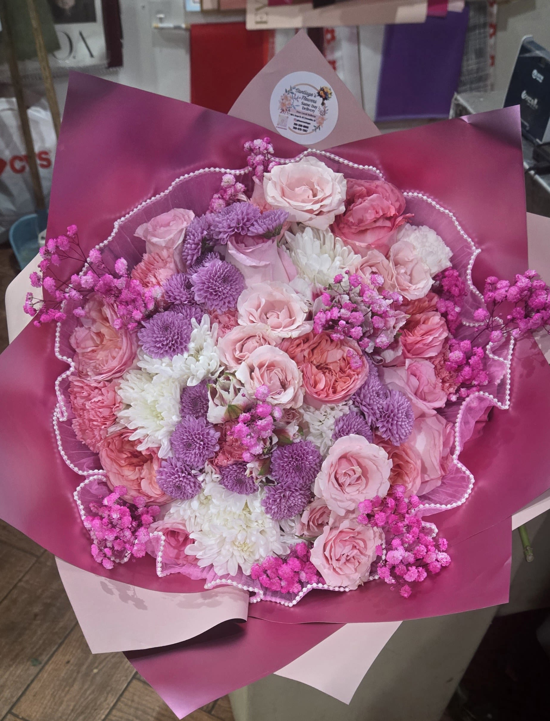 Bouquet of pink and purple flowers wrapped in magenta paper