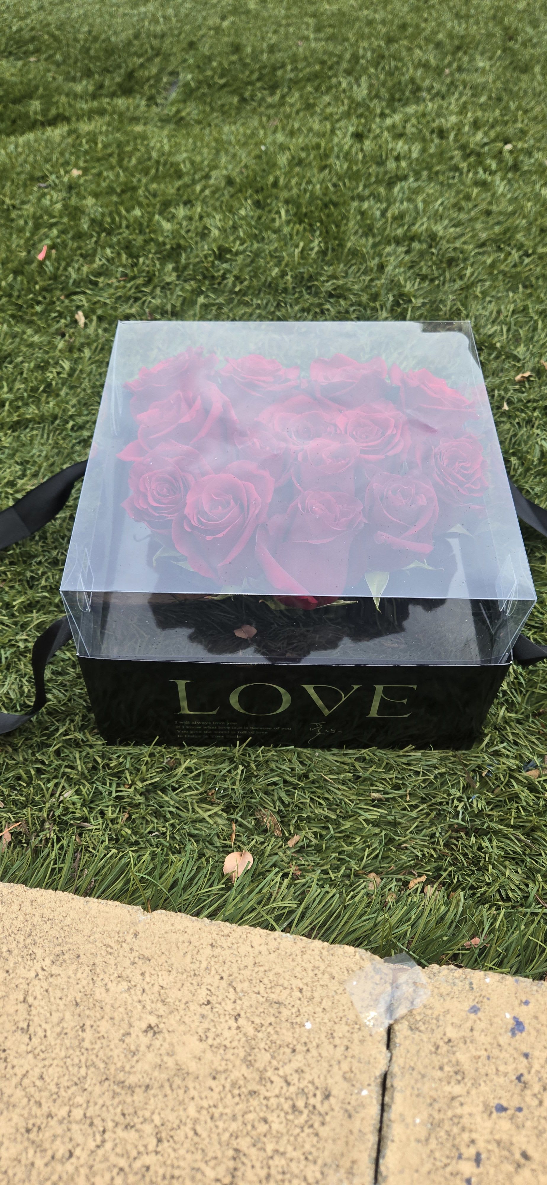 Boxed bouquet of pink roses in a clear lid gift box