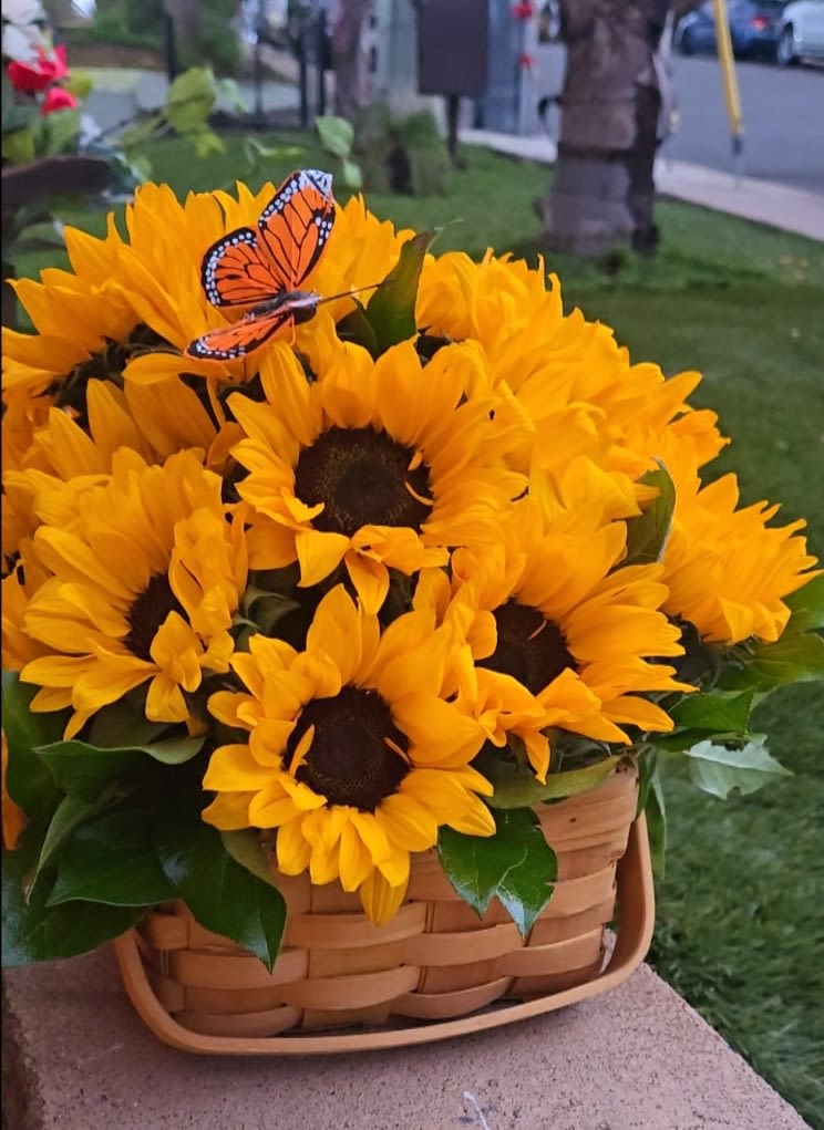 Basket of yellow sunflowers with a butterfly decoration