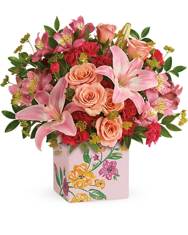 Teleflora's Brushed With Blossoms Bouquet - Glorious pink lilies and radiant peach roses send Mom your most heartfelt wishes for a happy Mother's Day! Presented in a keepsake ceramic cube, adorned with painterly blooms, it's two gifts in one for twice the fun. Beautiful peach spray roses, light pink asiatic lilies, pink alstroemeria and pink miniature carnations are arranged with bupleurum and huckleberry. Delivered in a Painted Blossoms cube.