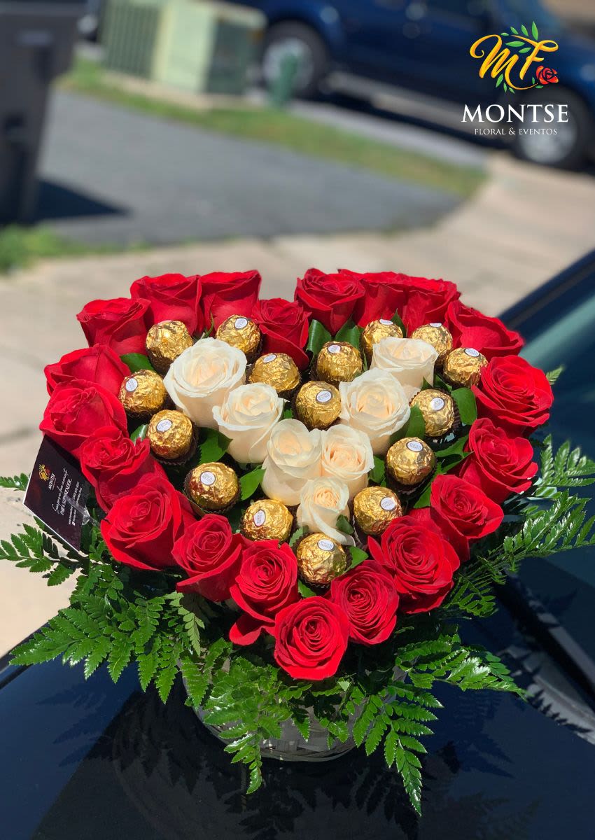 Heart-shaped bouquet of red and white roses with gold-wrapped chocolates