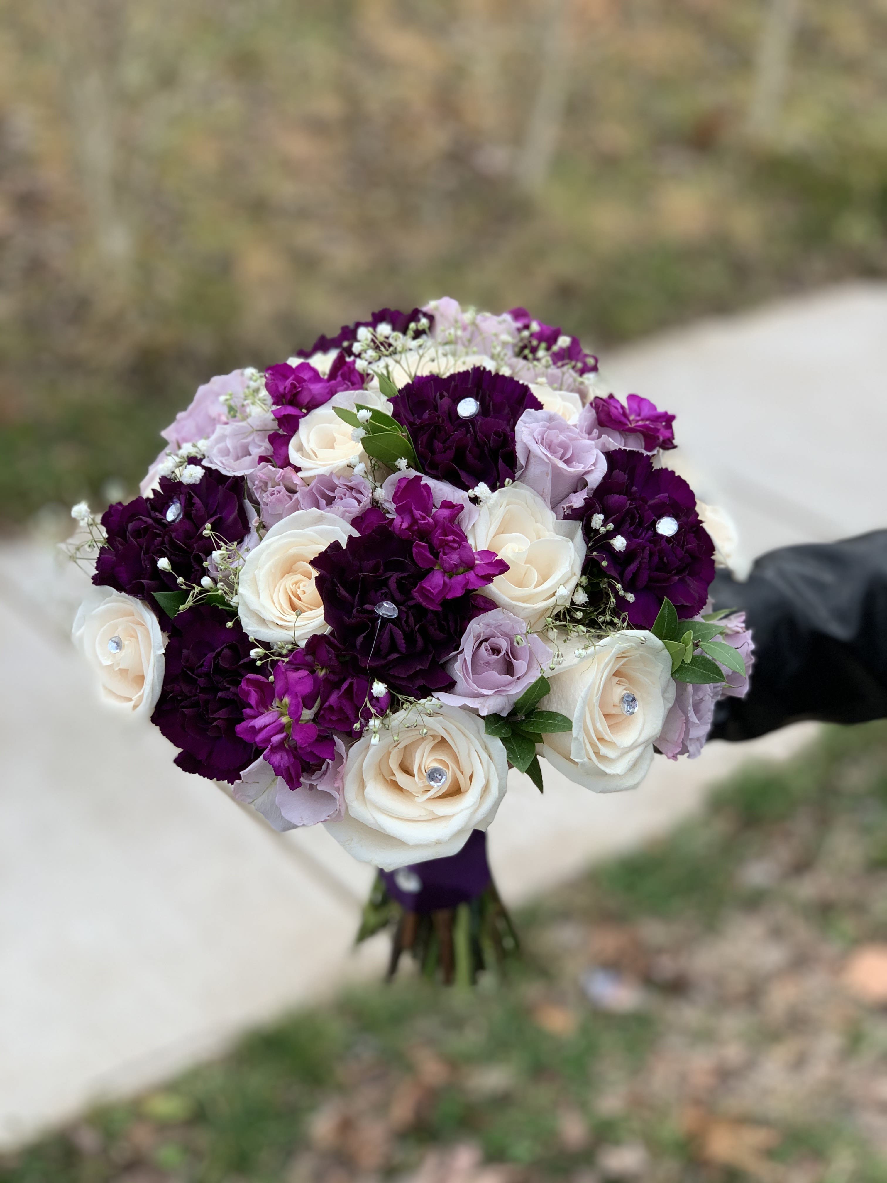 Bouquet of white, lavender, and deep purple roses
