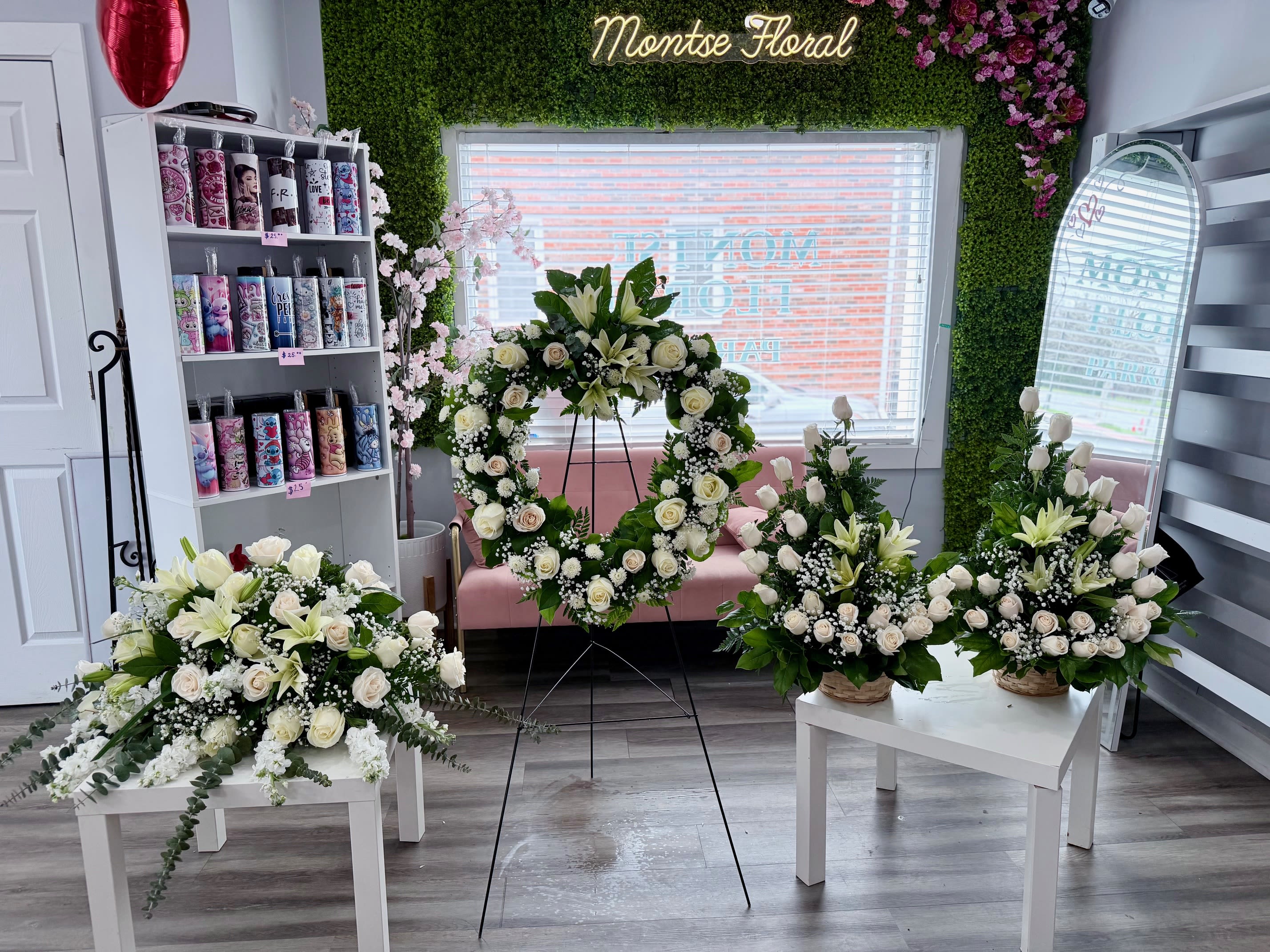 White rose and lily sympathy set with heart wreath on stand and coordinating sprays on white tables