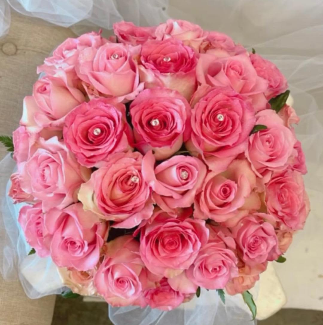 Round bouquet of pink roses with clear gem centers
