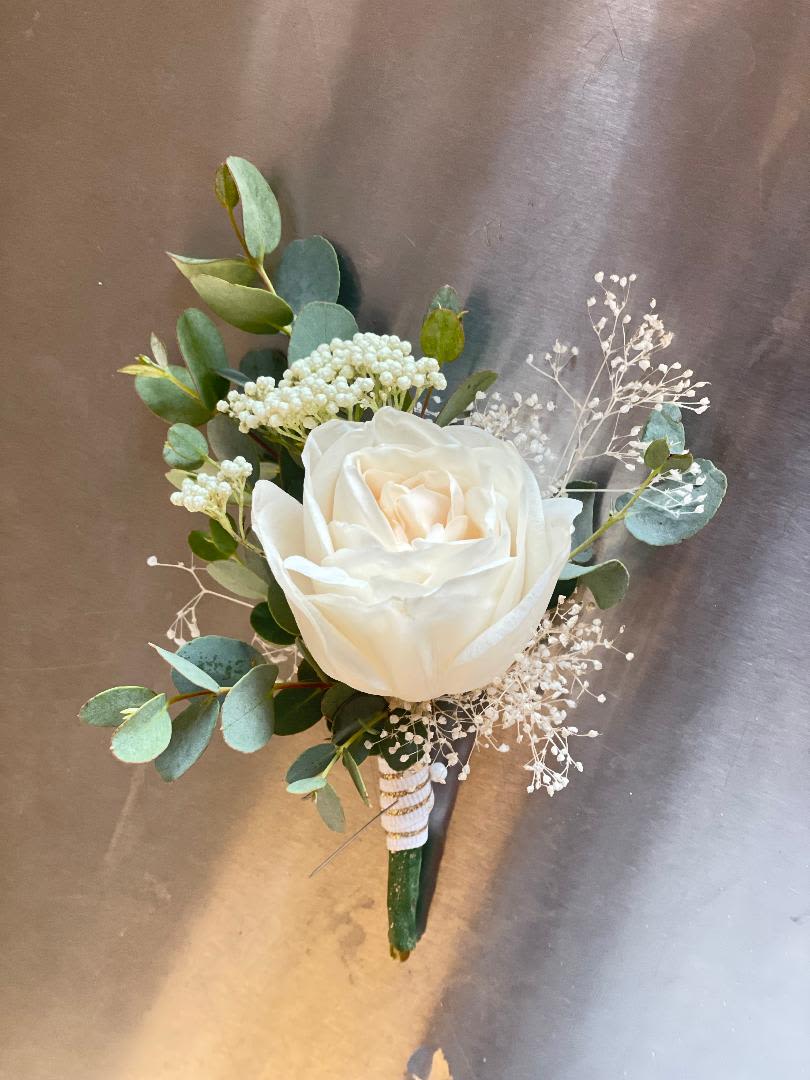 White rose boutonniere with eucalyptus and baby's breath