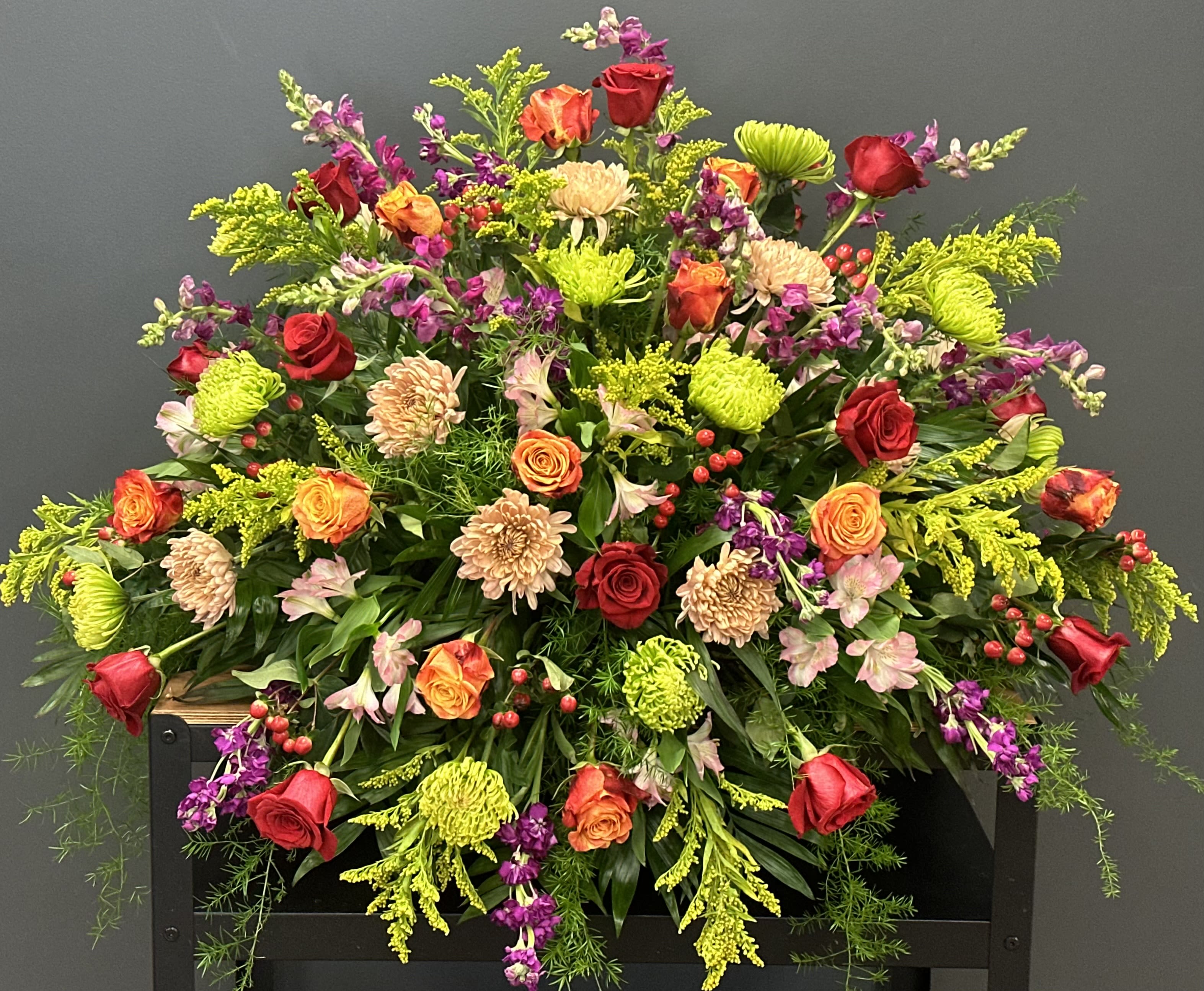 Large mixed bouquet of red, orange, and pink flowers