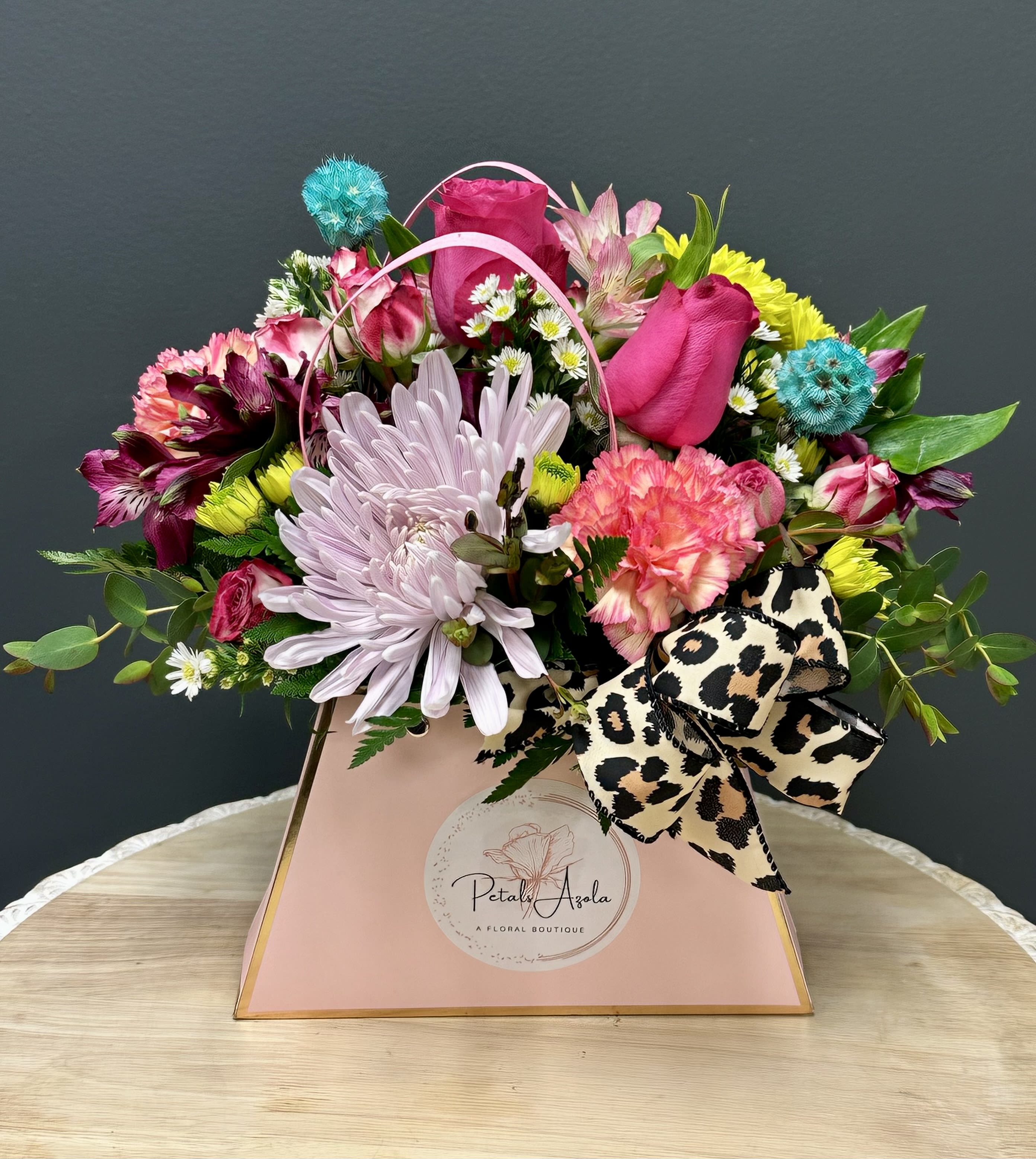 Mixed bouquet in a pink gift box with a leopard-print bow