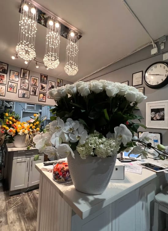 White clouds  - Playa Blanca 50 rose arrangement  Deluxe 75 roses and premium 100 roses imported from Ecuador plus additional white Flowers in season. 