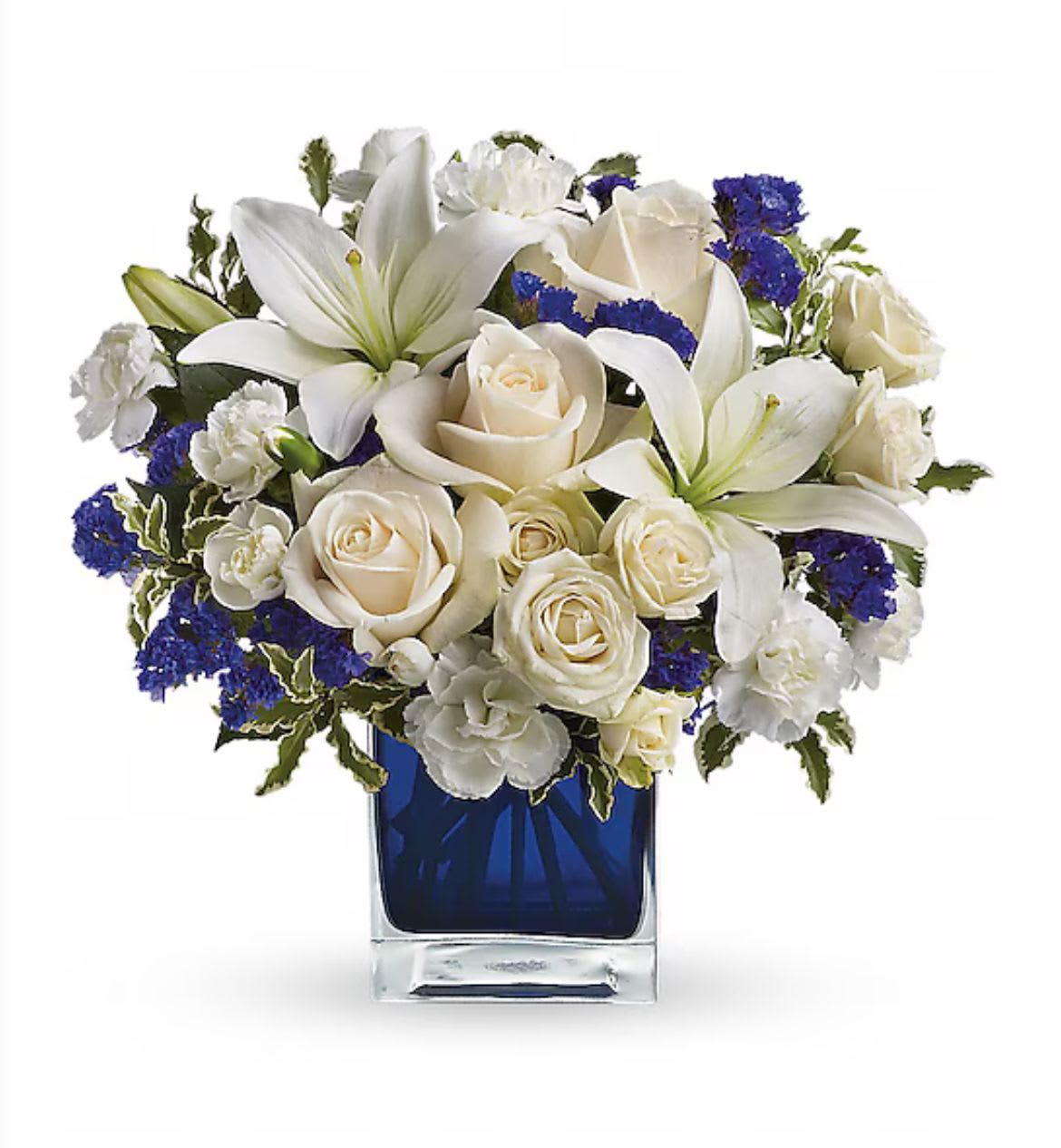 Blue skies - Stunning arrangement of white lilies, roses, mums, carnations, and touch of blue accent in a blue square container 