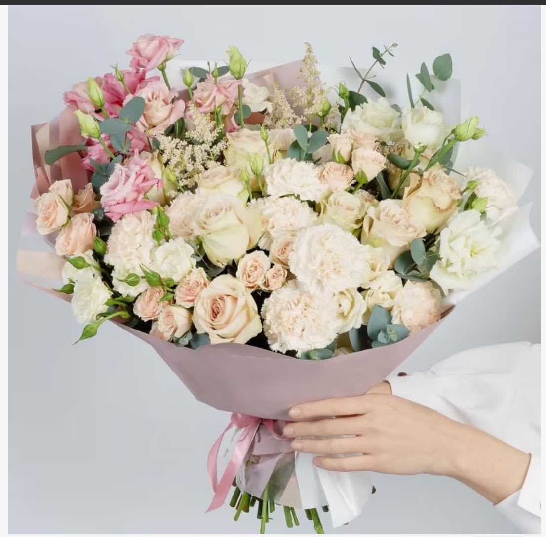 Large bouquet of pale pink and white roses with ribbon wrap